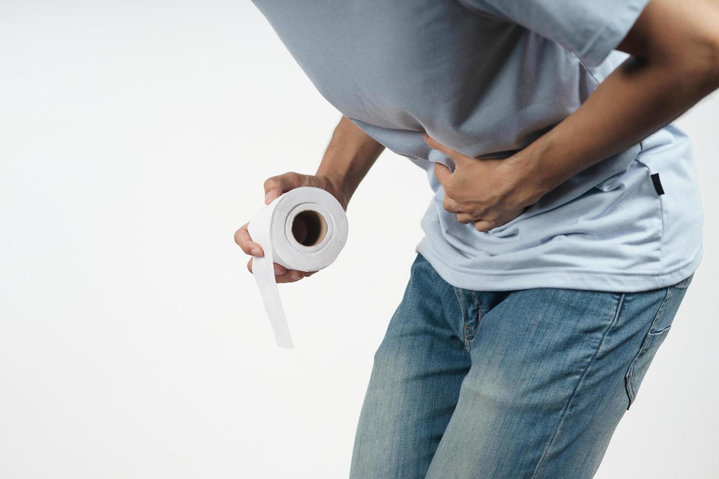 Man hold his stomach and tissue paper suffering from diarrhea photo