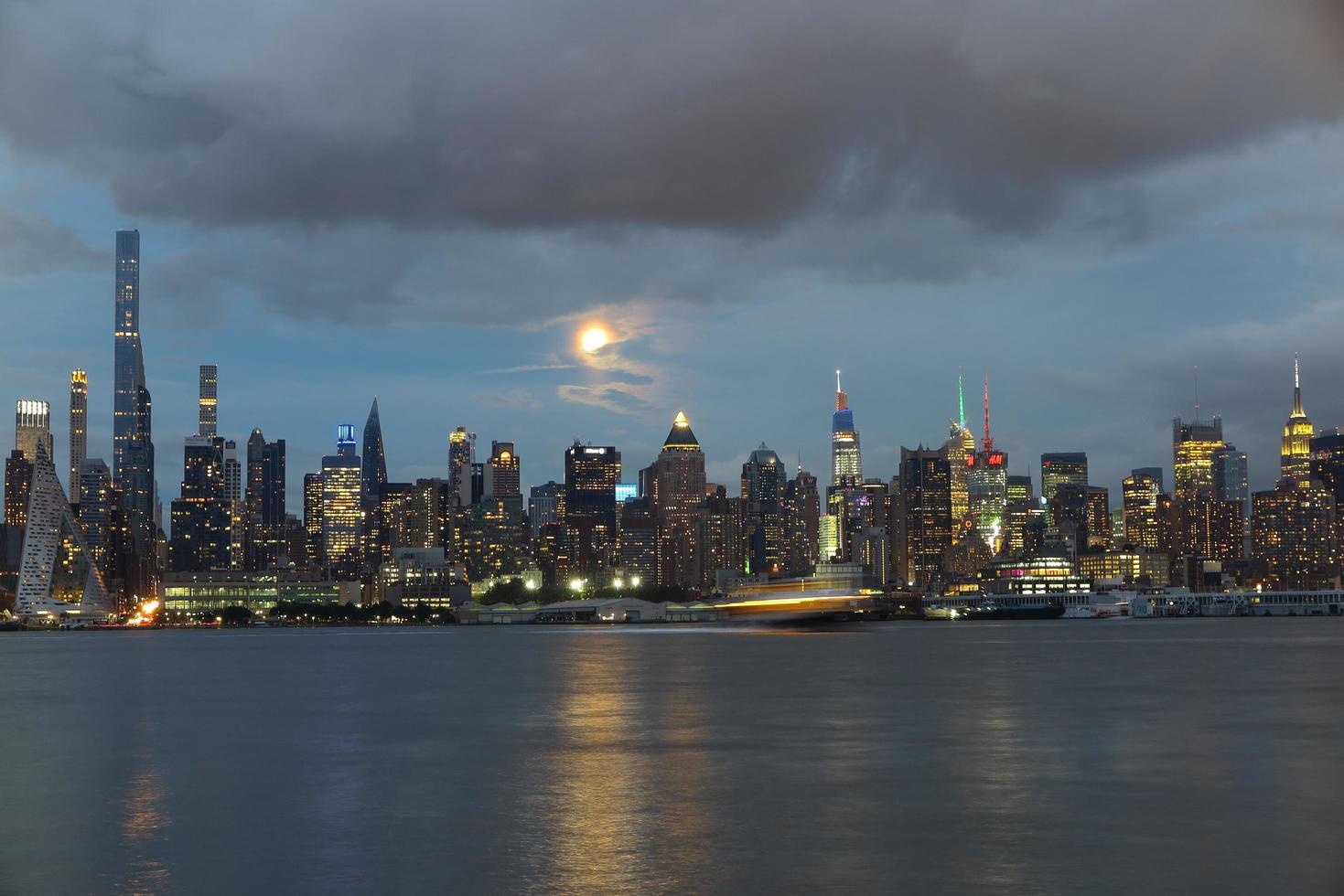 Beautiful Manhattan night view and moon seen from New Jersey photo