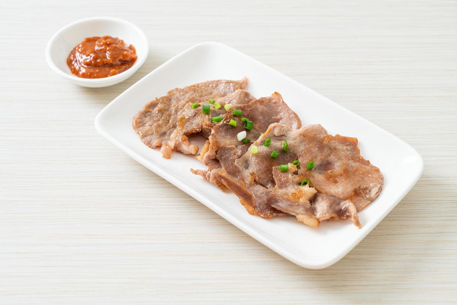 Grilled pork neck sliced on plate photo