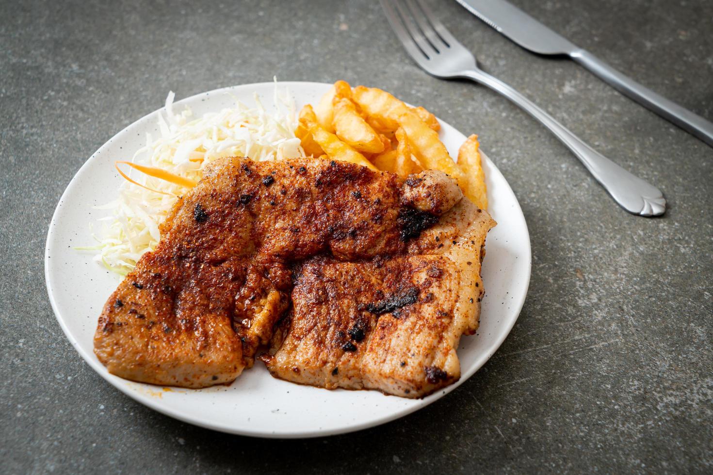 Grilled spicy barbecue pork steak with french fries photo