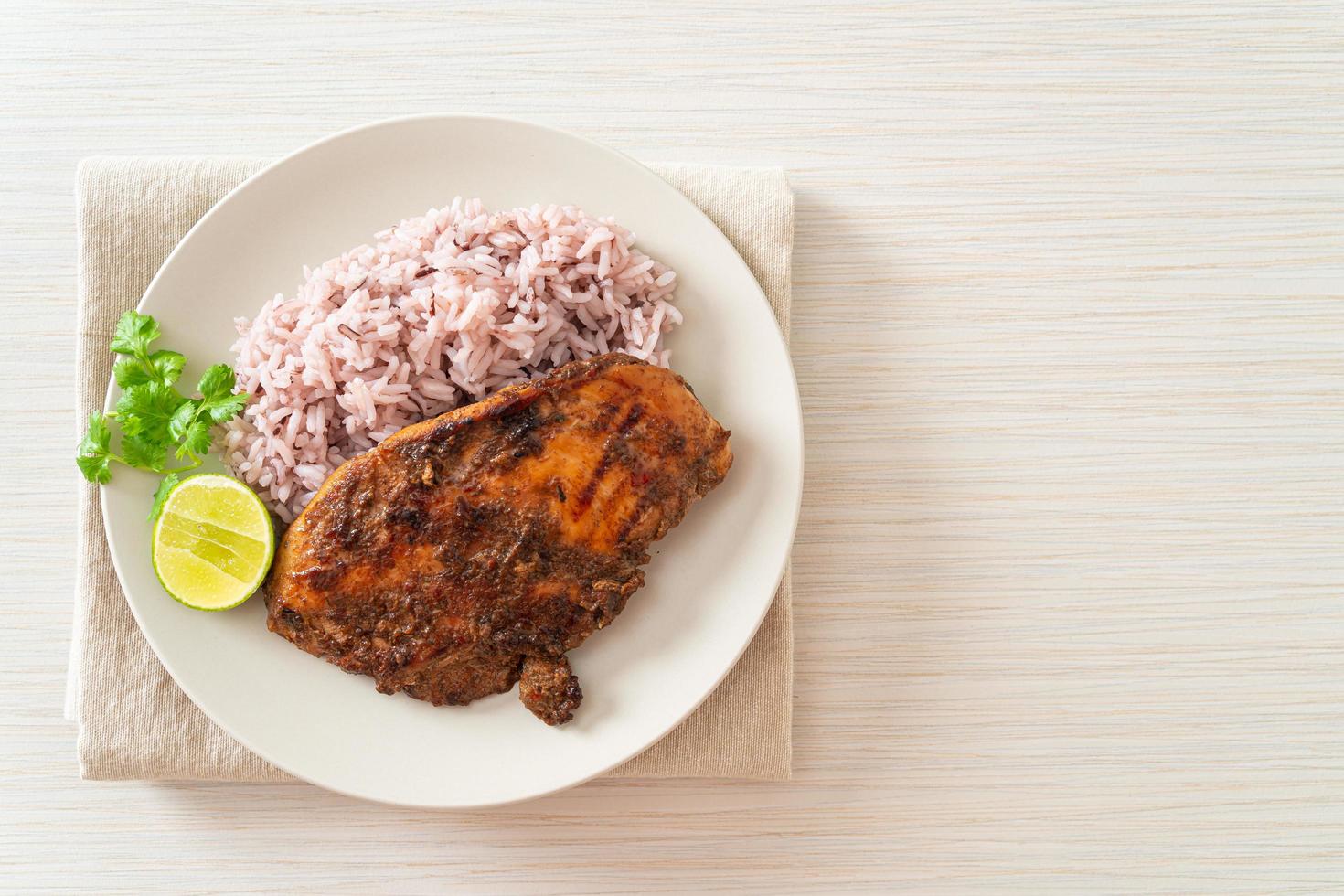 Spicy grilled Jamaican jerk chicken with rice photo