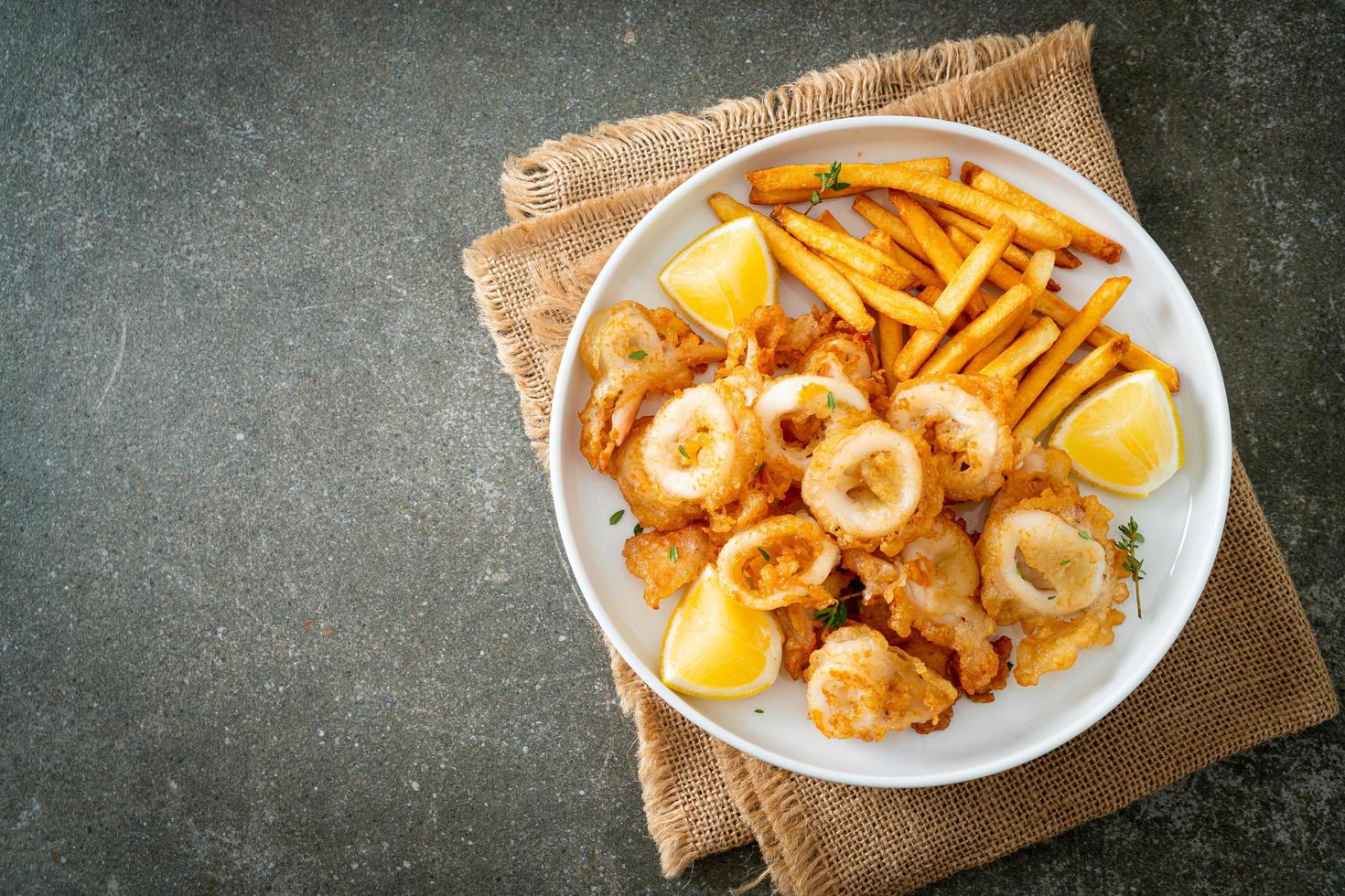 Calamari - fried squid or octopus with fries photo