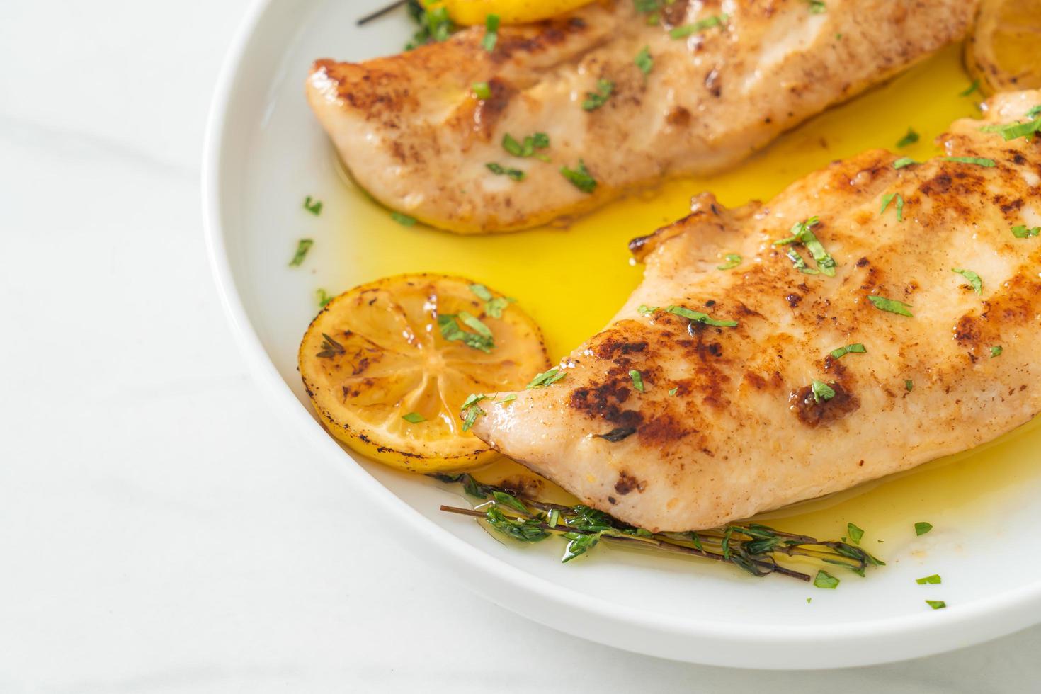 Grilled chicken with butter, lemon and garlic photo