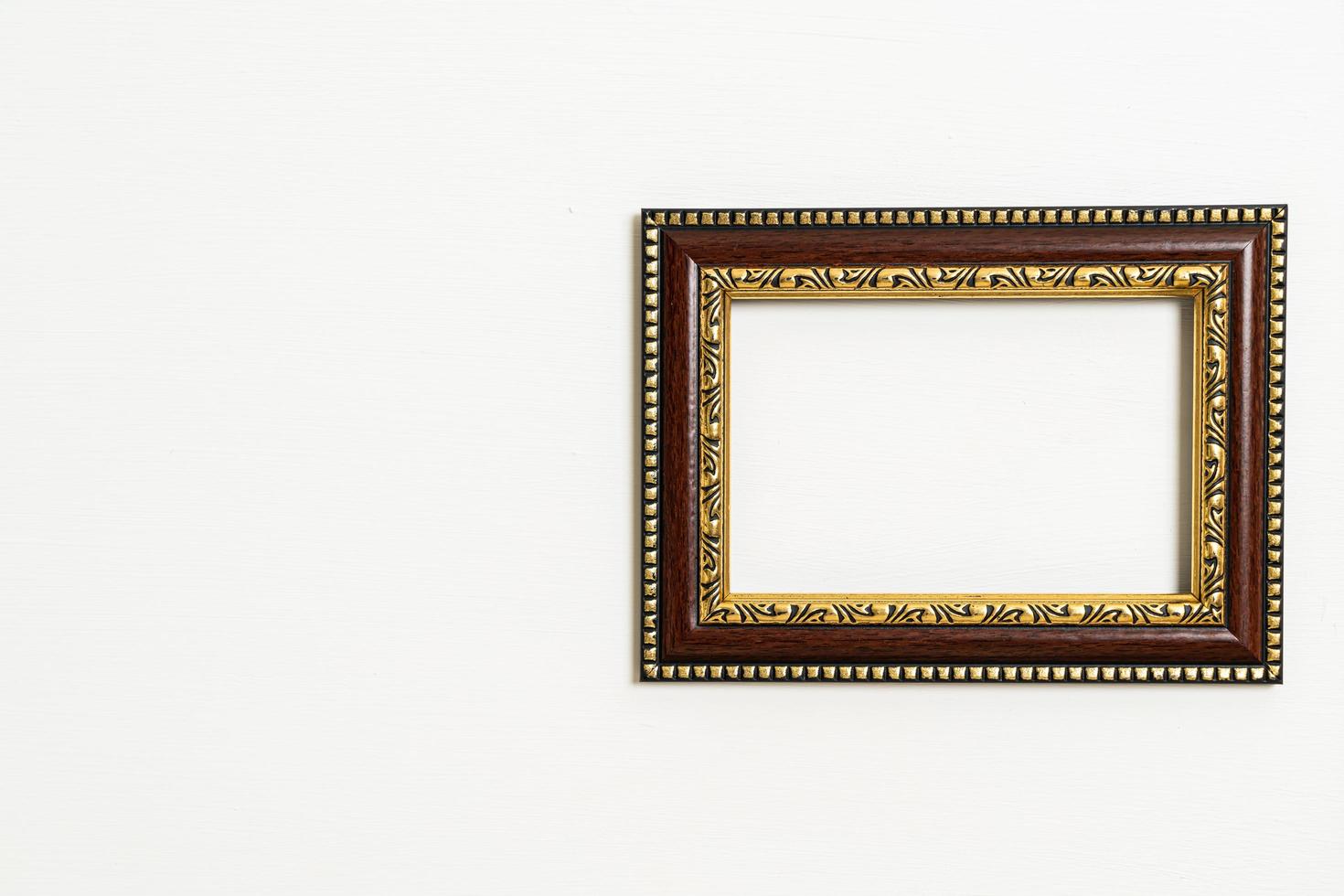 Empty picture frame on white wall background photo
