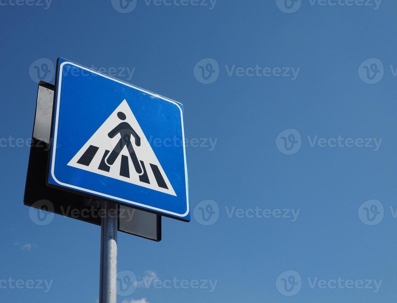 Zebra crossing sign over blue sky photo