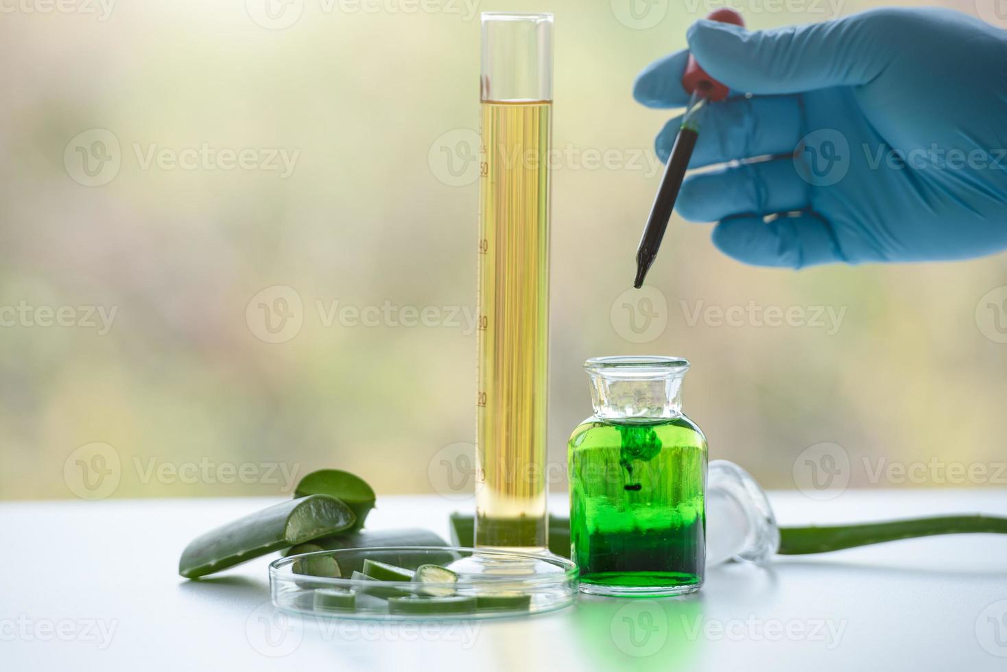 Aloe vera spa treatments on white wooden table with scientist hand photo