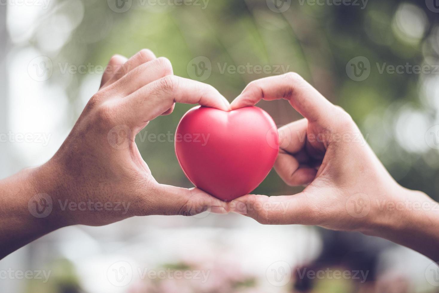 Couple in love making heart symbol shape with finger hands together photo