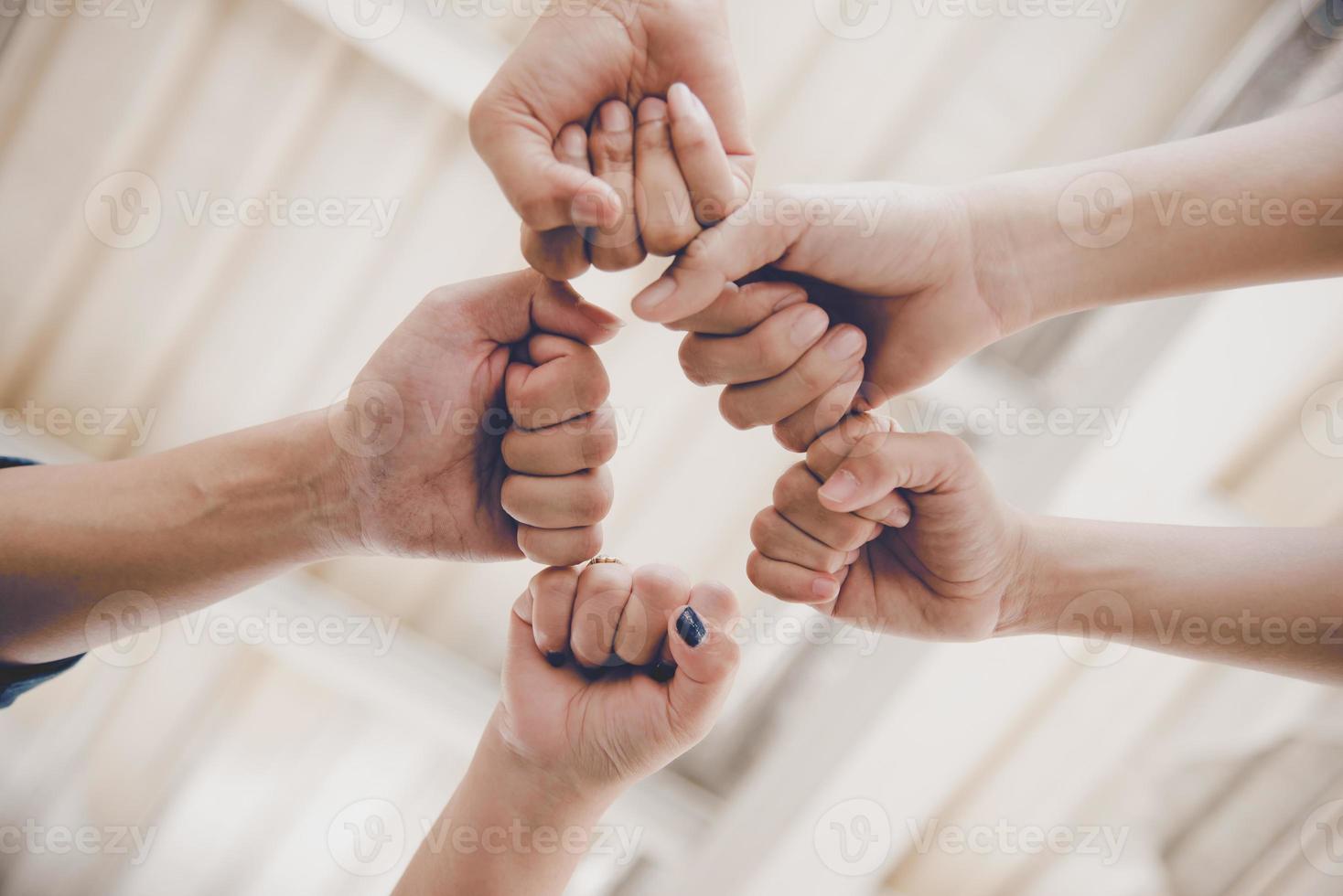 Business partnership giving fist bump to start up new project photo