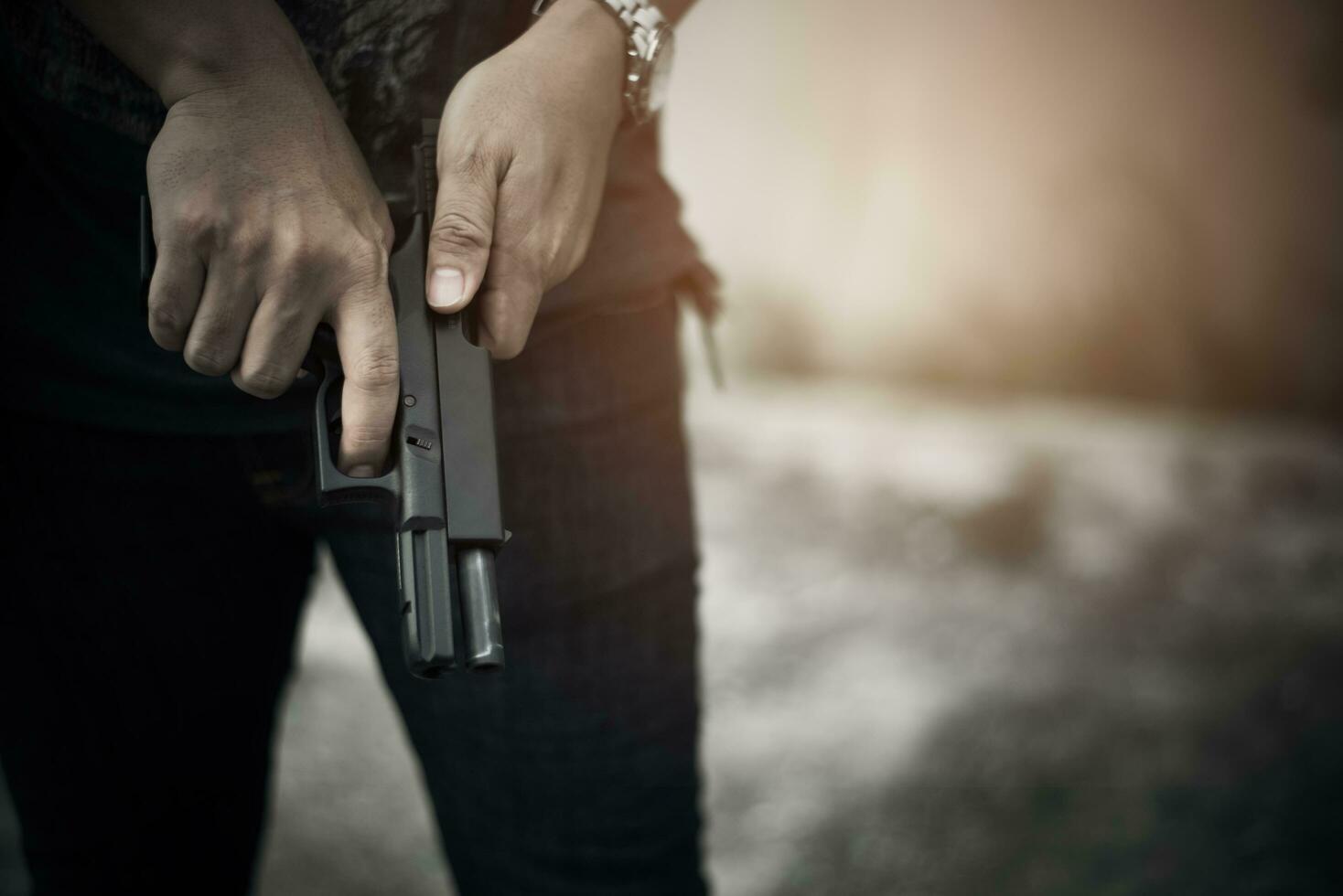 Robber holding gun for ready to murder steal moneys photo
