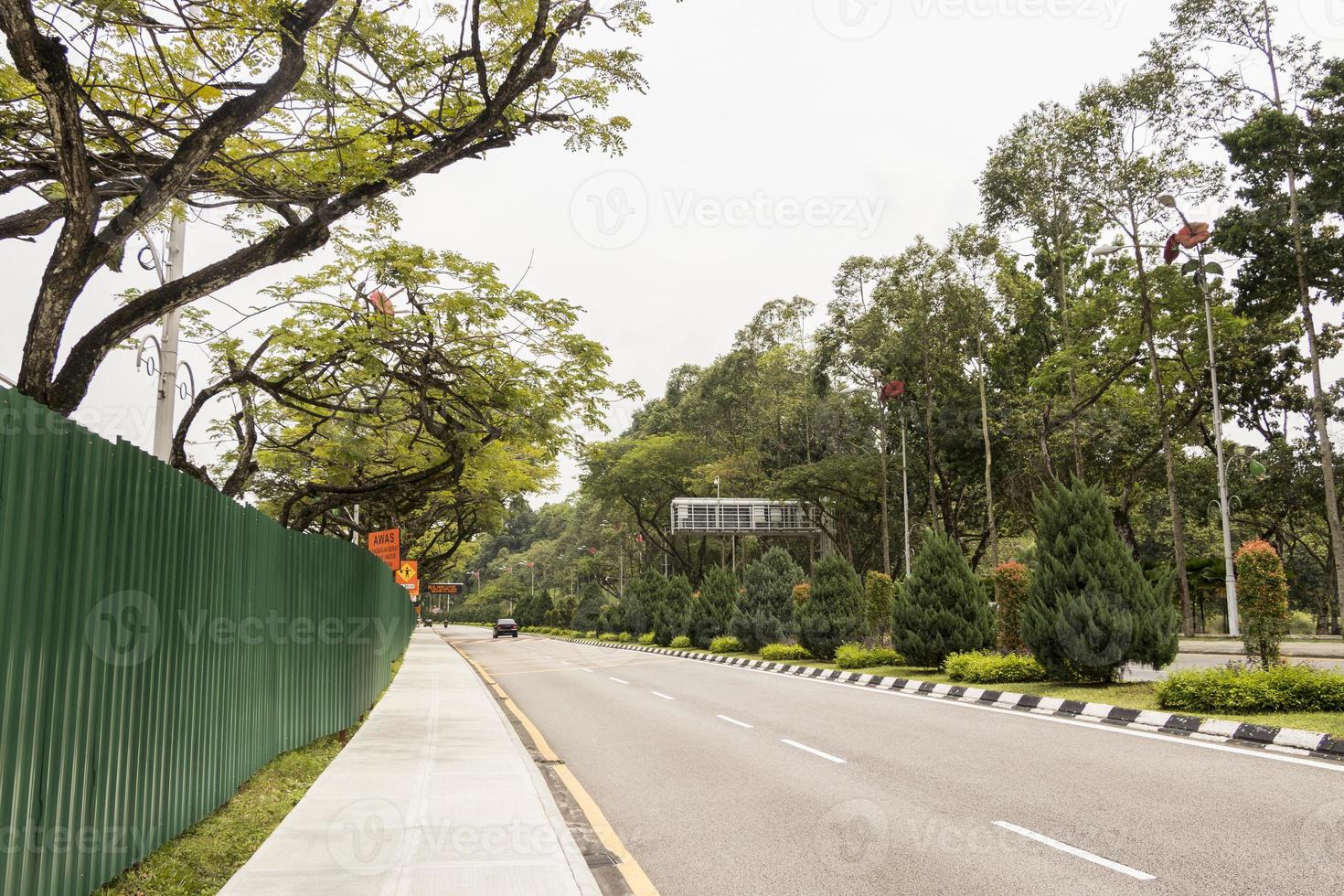 Road between nature and construction site in Kuala Lumpur, Malaysia. photo