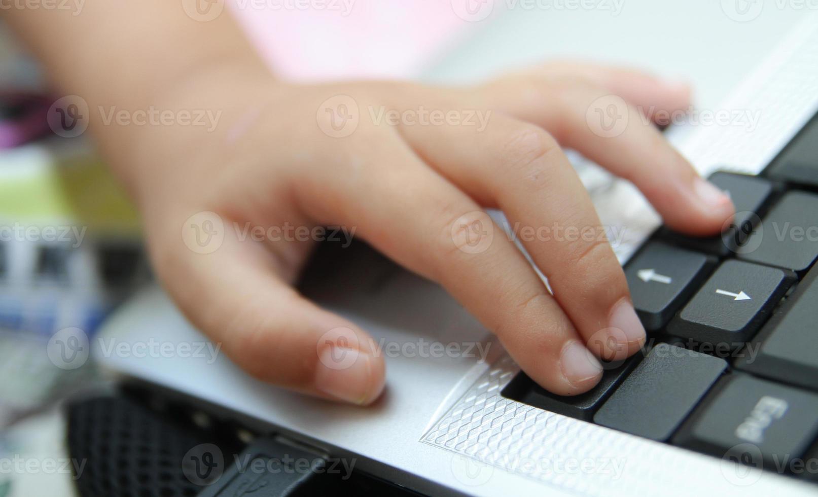 Child learns online and plays game on the computer at home. photo