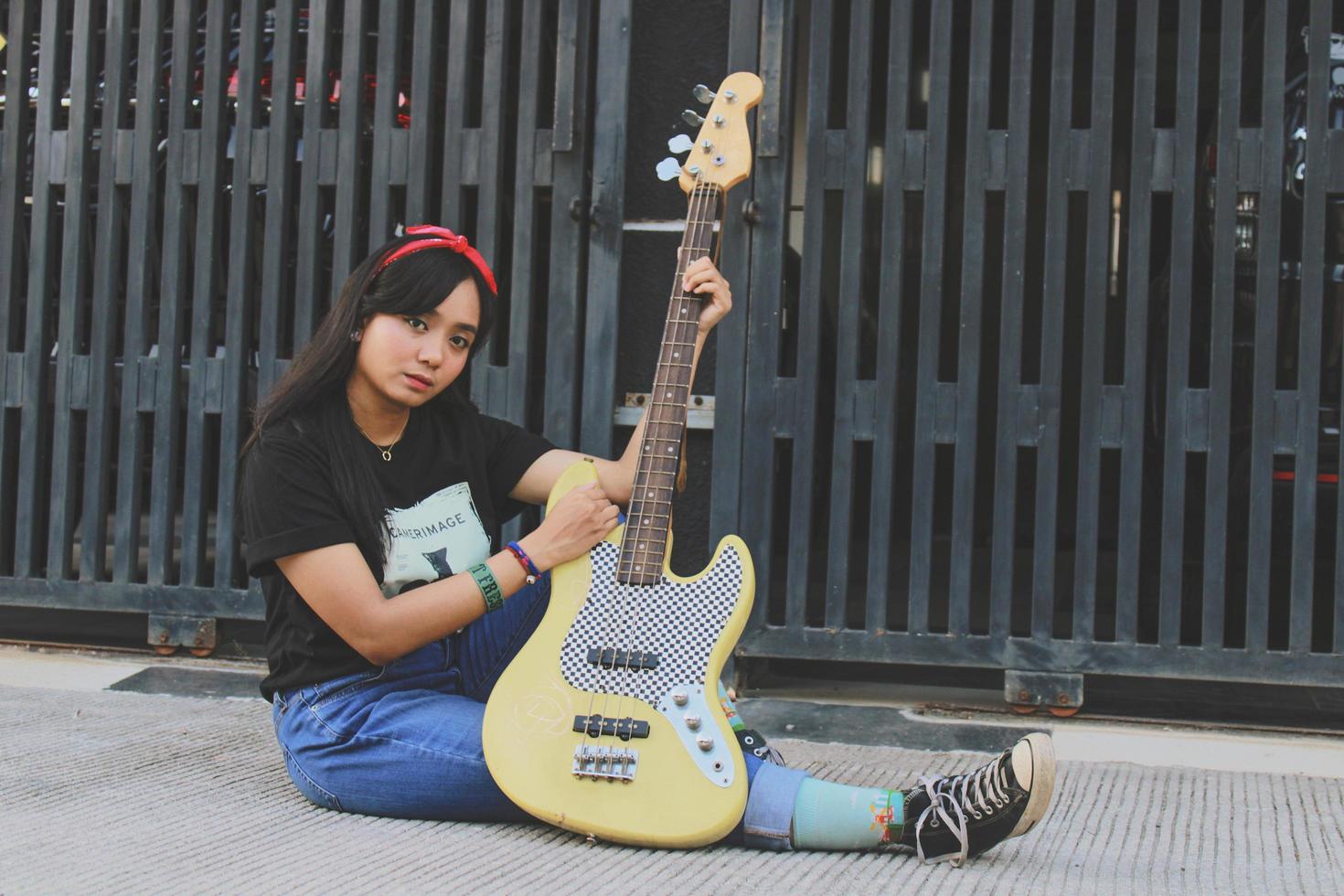 rock band cool girl portrait holding her bass guitar photo