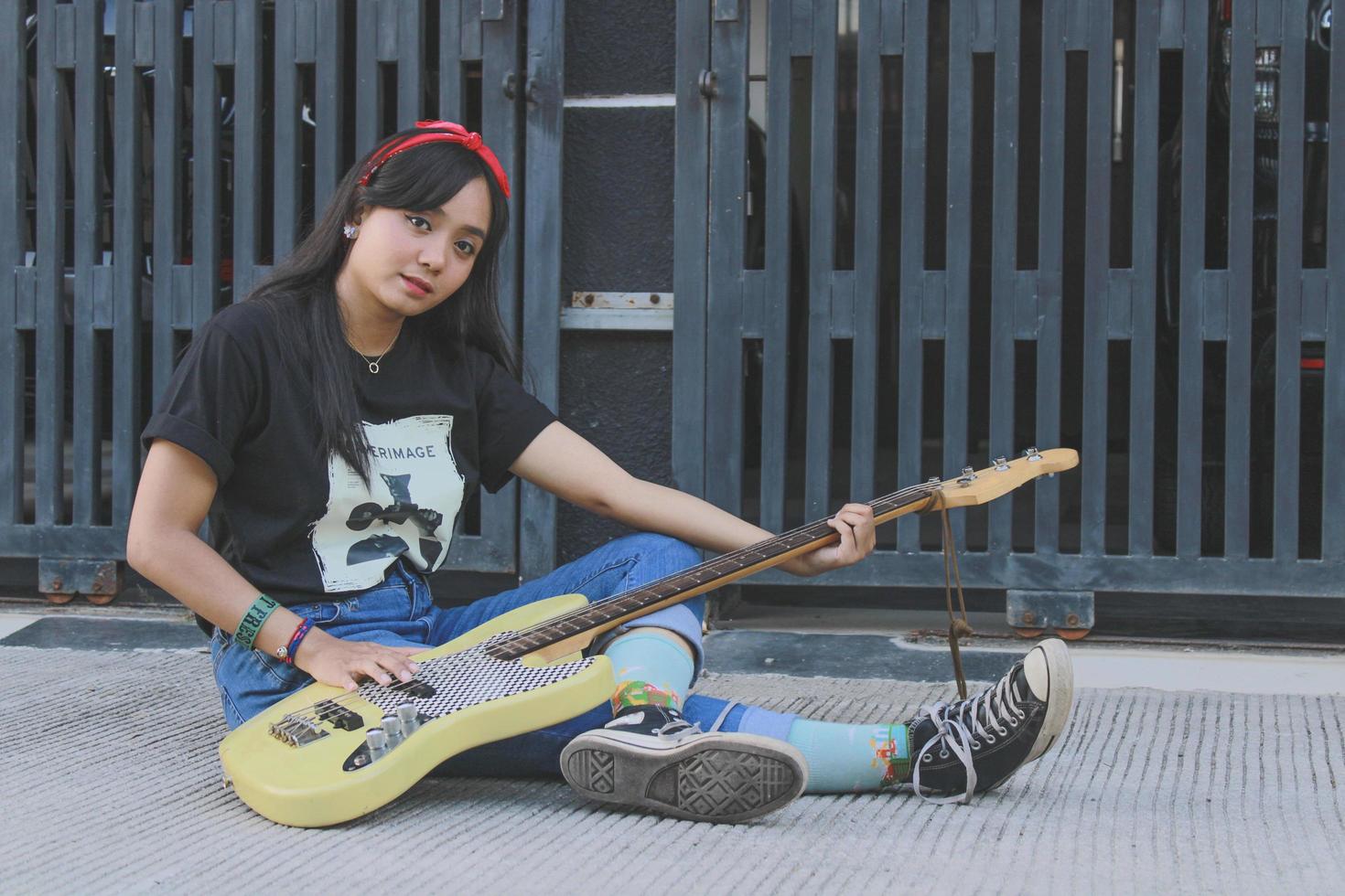 rock band cool girl portrait holding her bass guitar photo