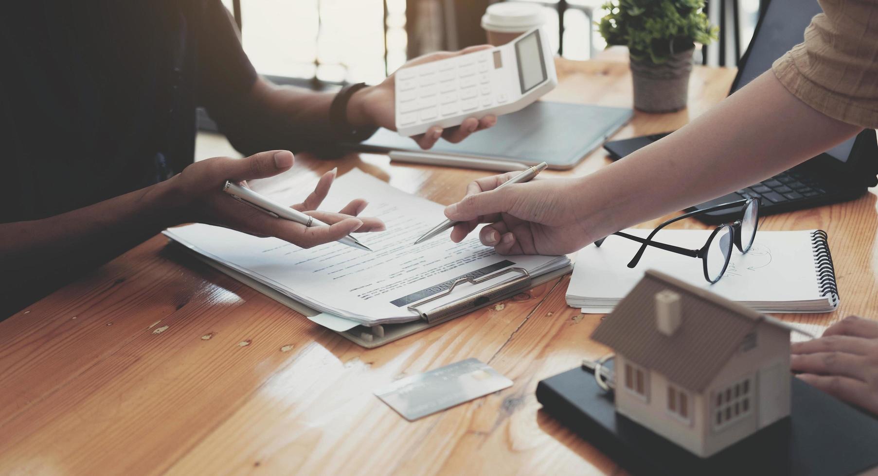 Cropped image of real estate agent assisting client to sign contract photo