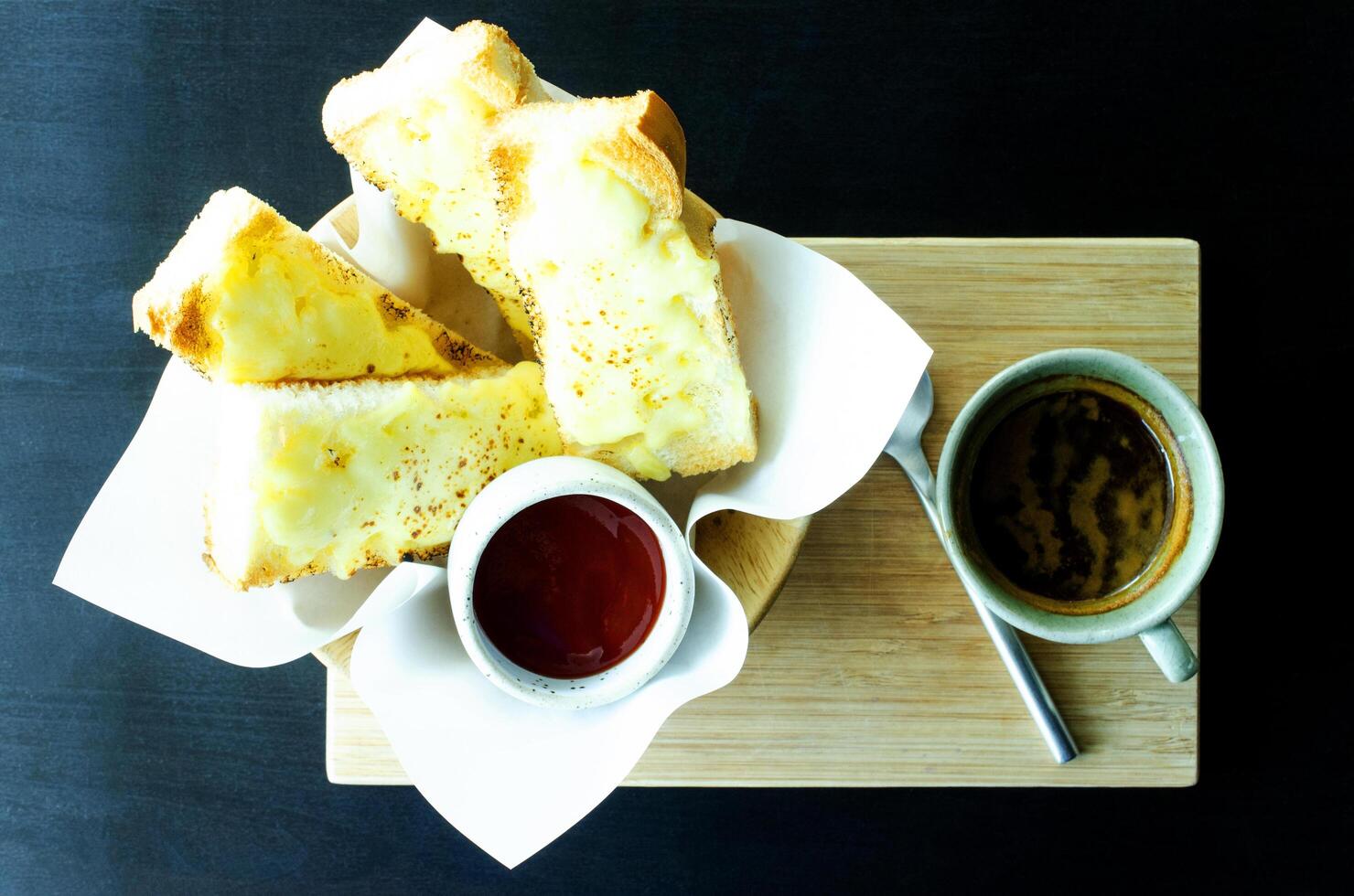 Cheesy Garlic Bread and black coffee drink on table backgrounds photo