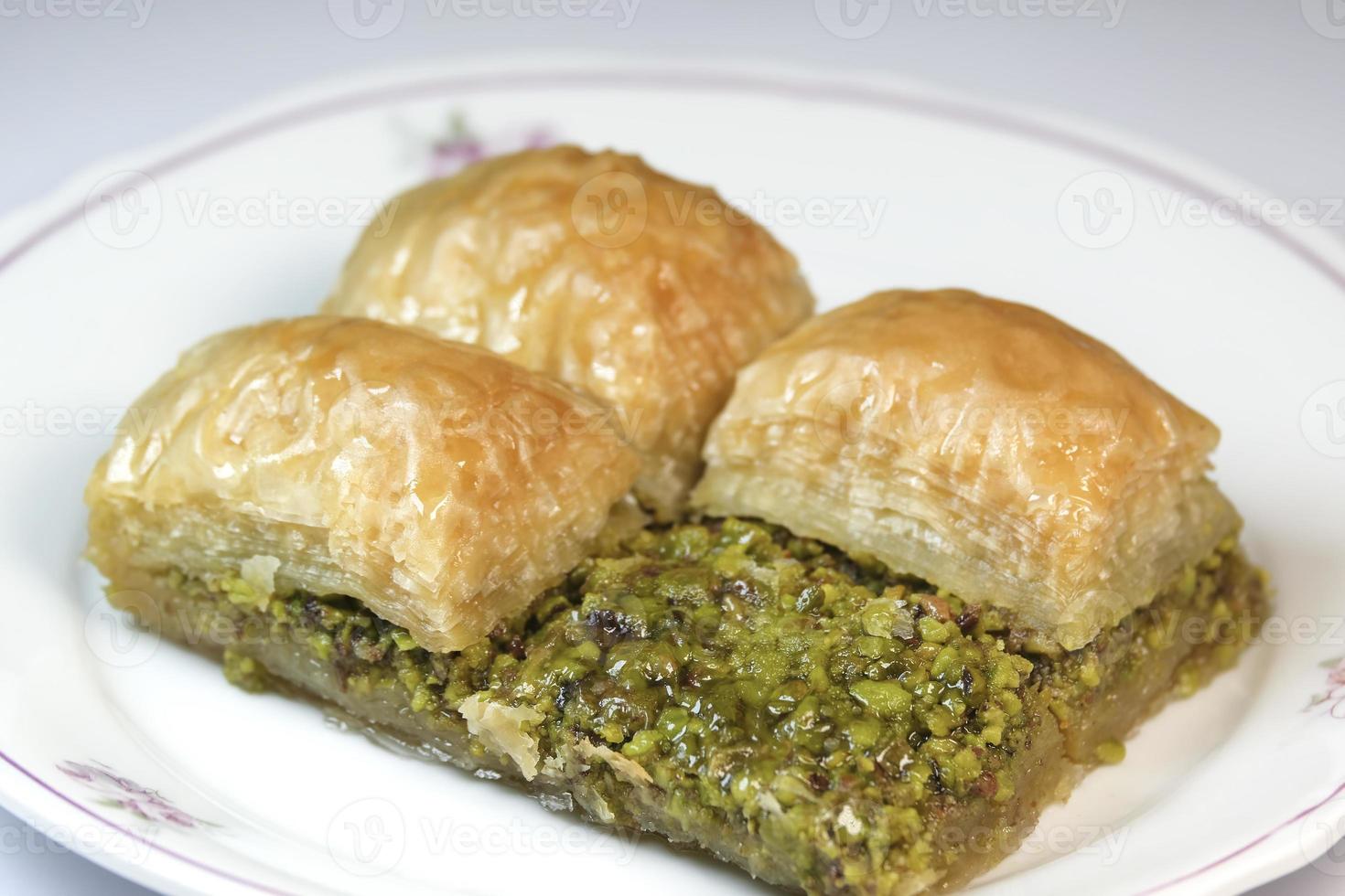 Delicious pistachio baklava on a white dish photo