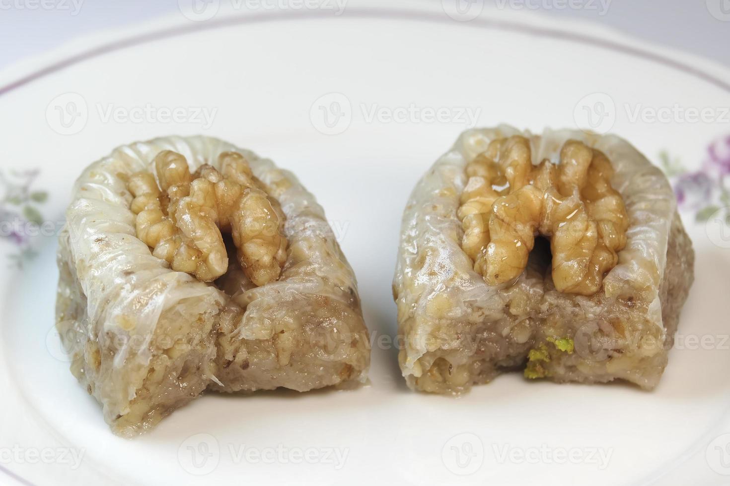 Delicious walnut baklava on a white dish photo