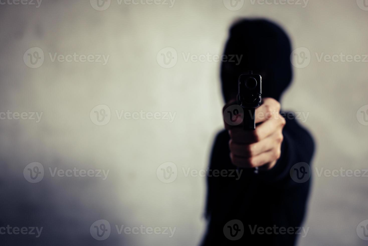 Man aiming gun and ready to shoot on front view photo