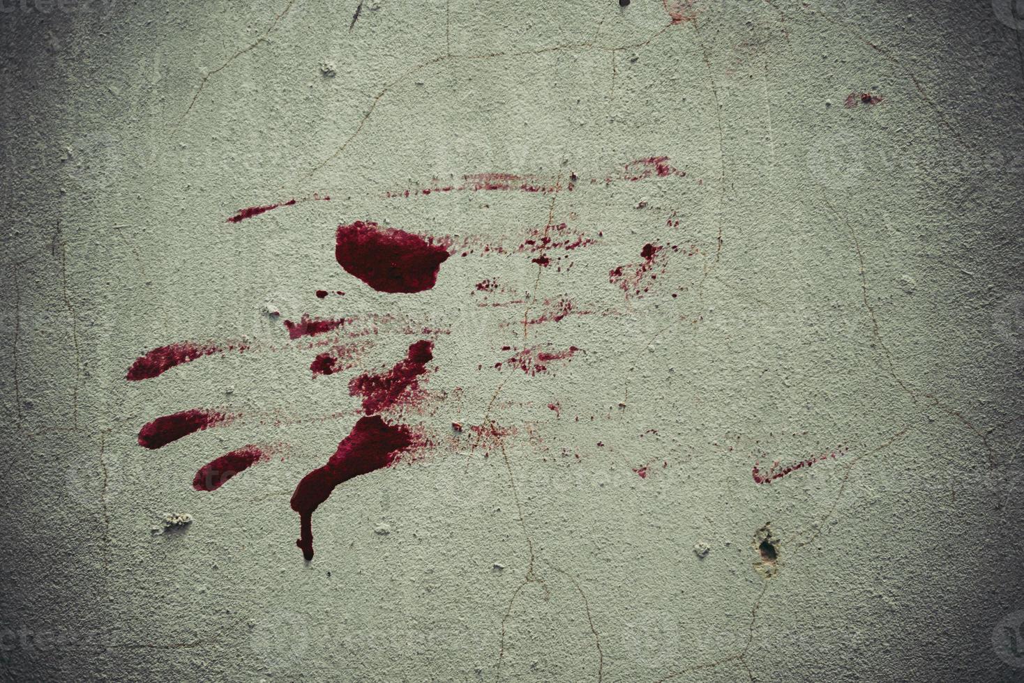 Red blood like hand shape stuck on the grunge wall photo