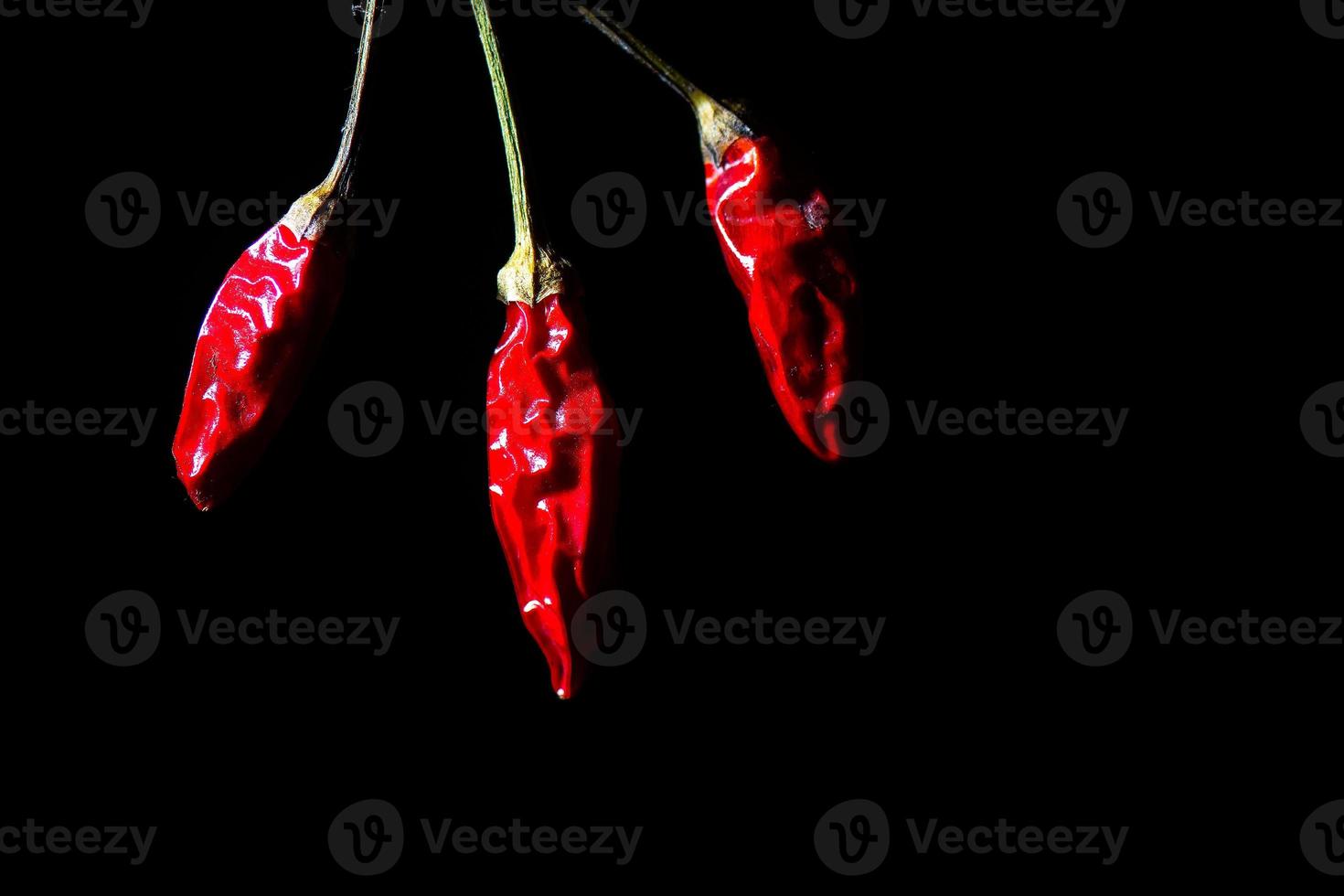 Detail of chili peppers on a black background photo