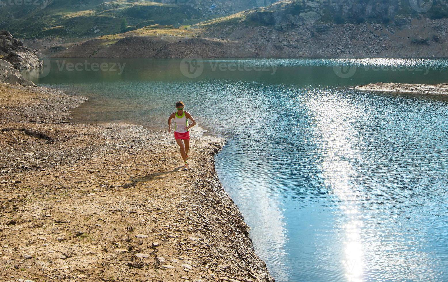 Running near mountain lake photo