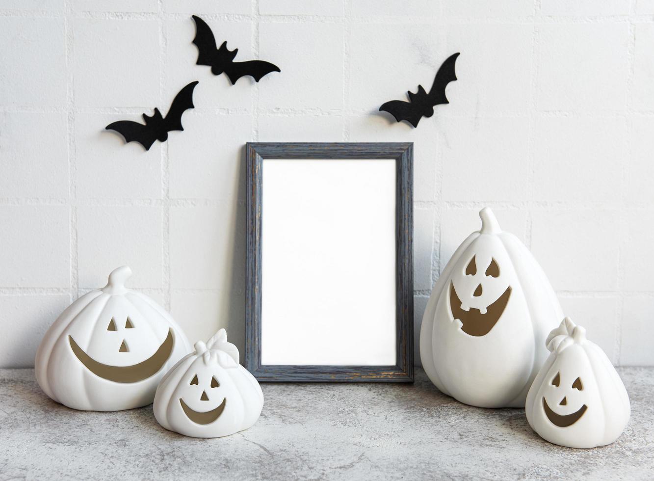 Mock up frame with Jack o Lantern and pumpkin decor on a table photo