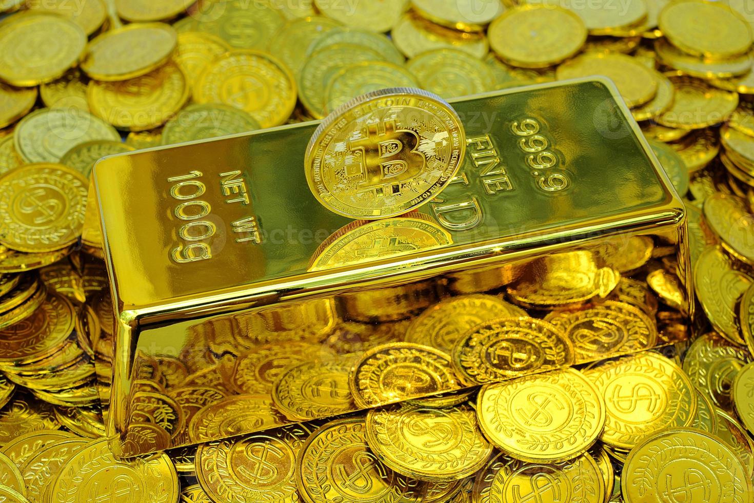 Bitcoin cryptocurrency on the gold bar and pile gold coin photo