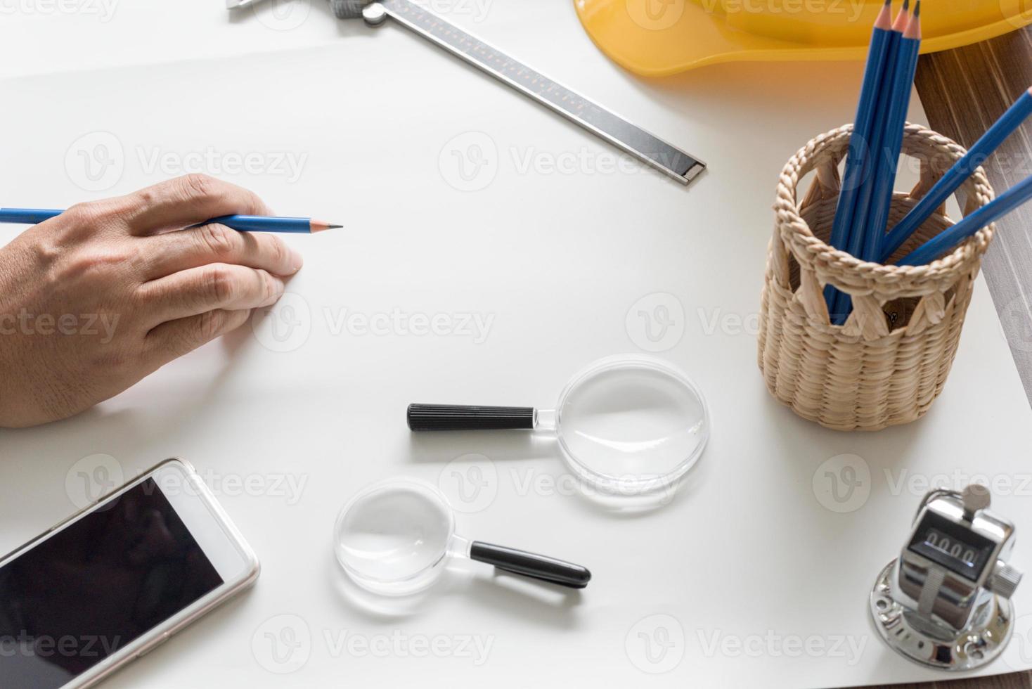 Close up of architect sketching a construction blueprint project photo