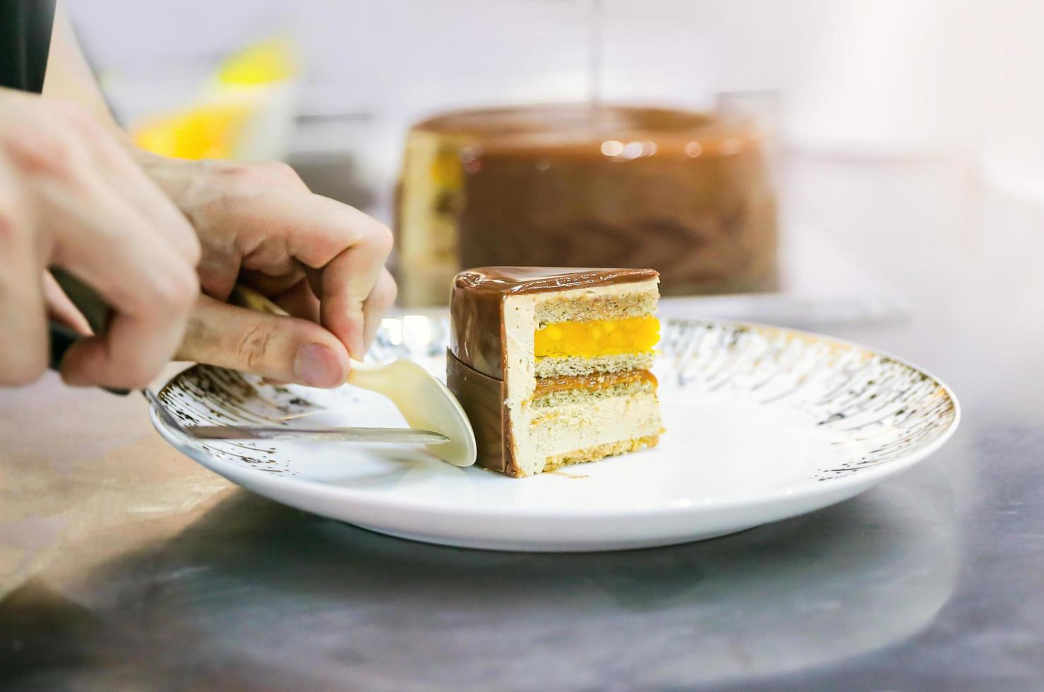 Pastry chef cutting homemade chocolate cake photo