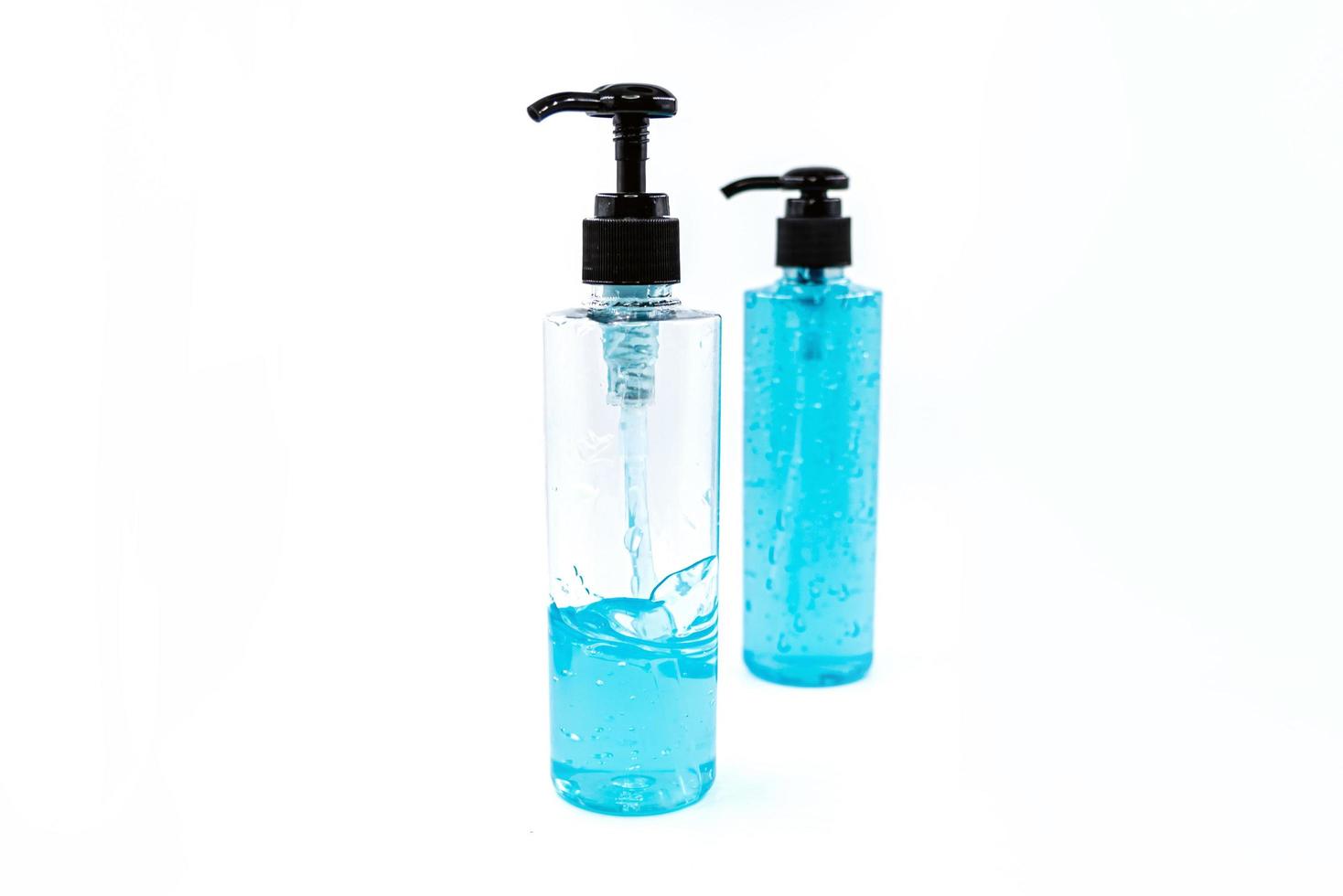 Blue alcohol sanitizer gel bottle with pump for hand wash photo