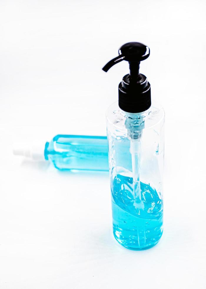 Blue alcohol sanitizer gel bottle with pump for hand wash photo