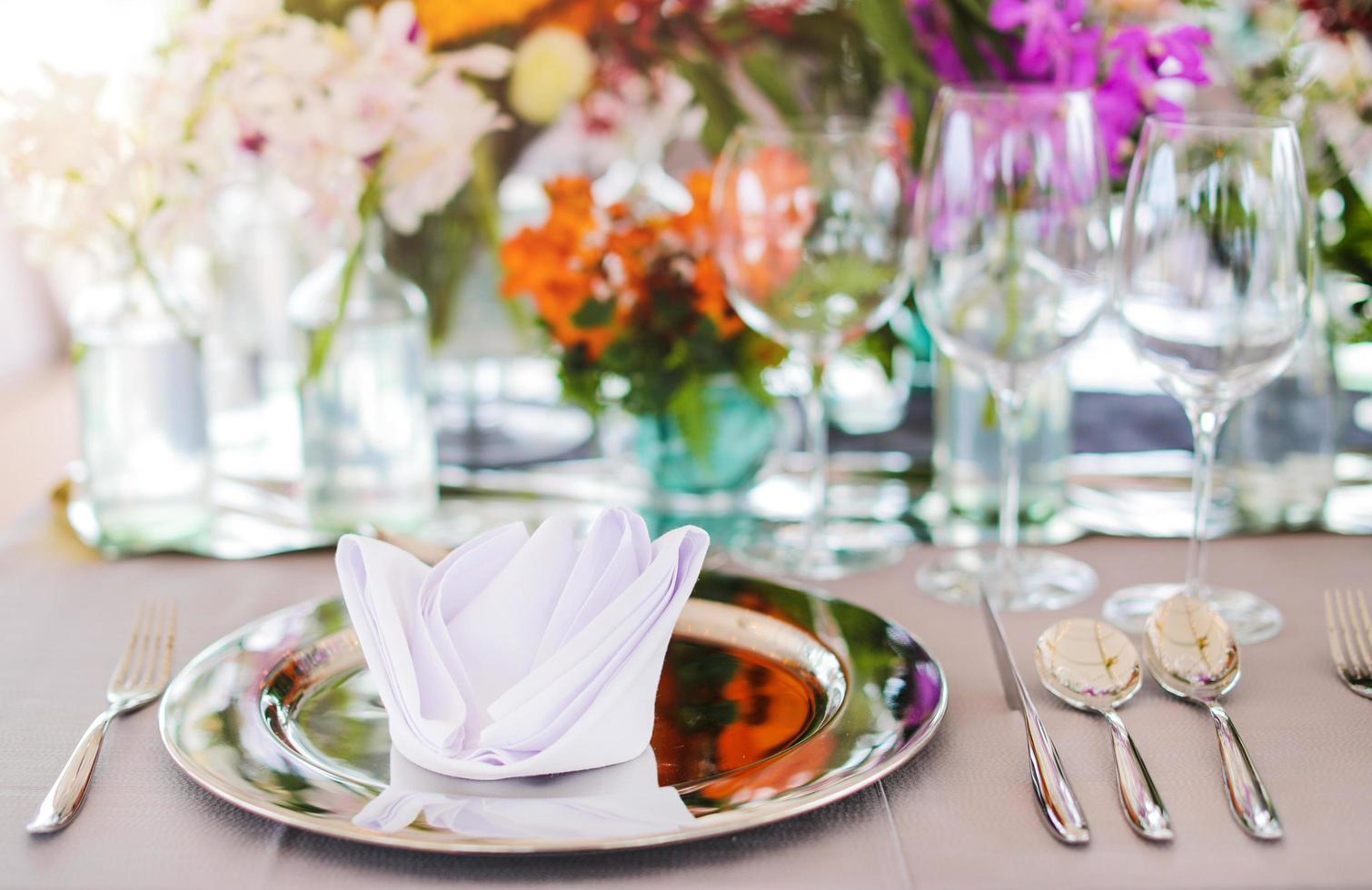 Table setting for a wedding or dinner event, with flowers photo