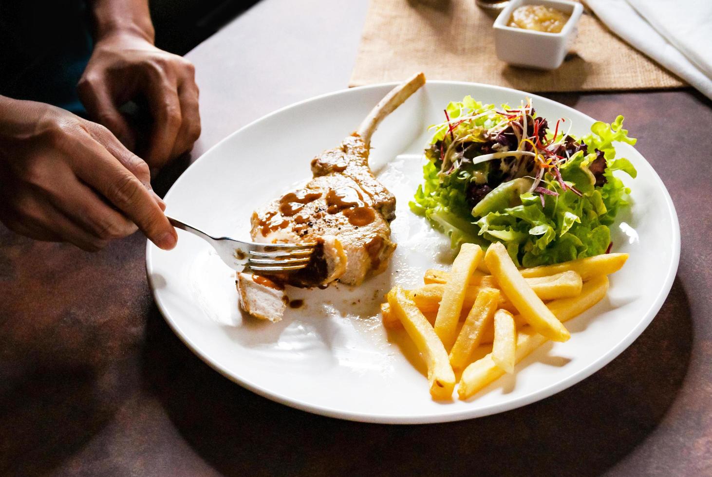 Pork chop steak with salad and french fries photo