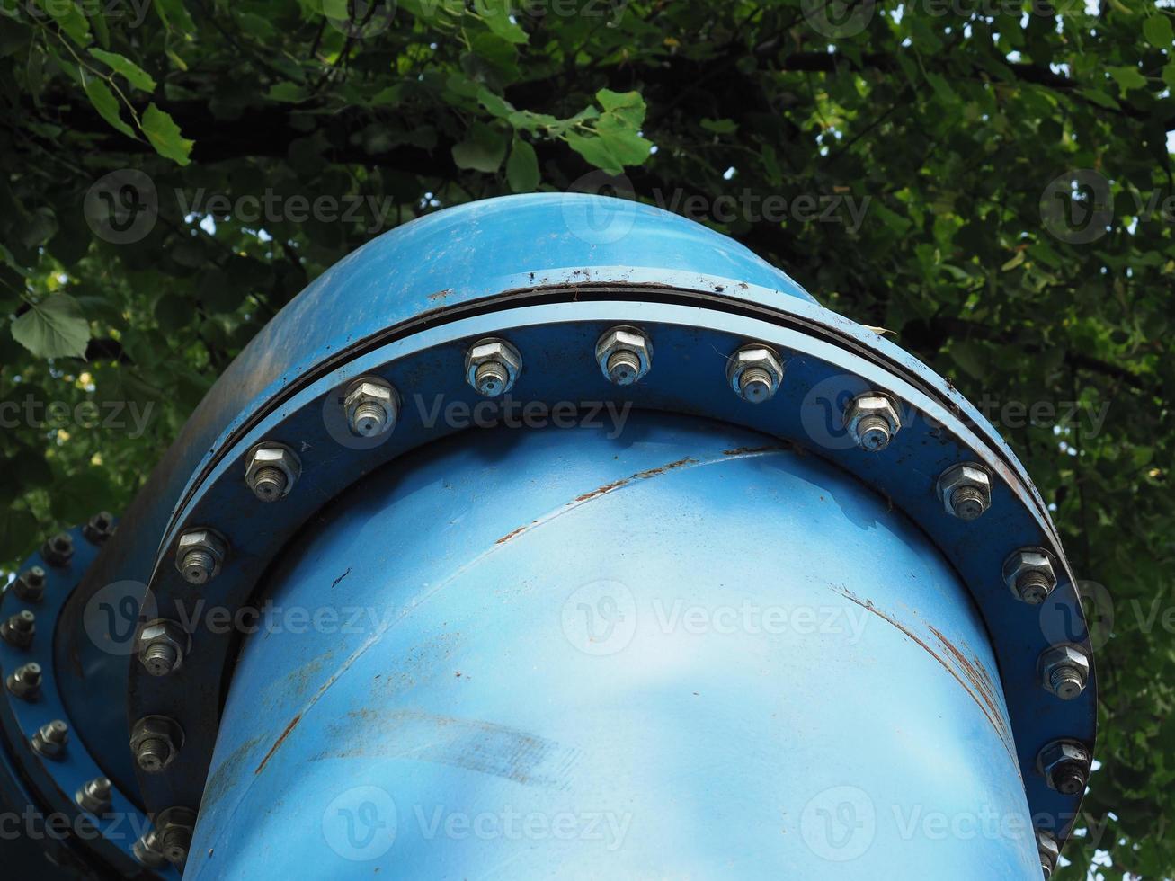 Big blue steel water pipe with bolts photo