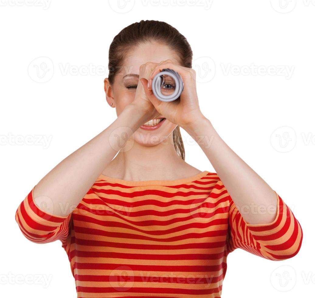 Girl looks in a folded magazine - spyglass photo