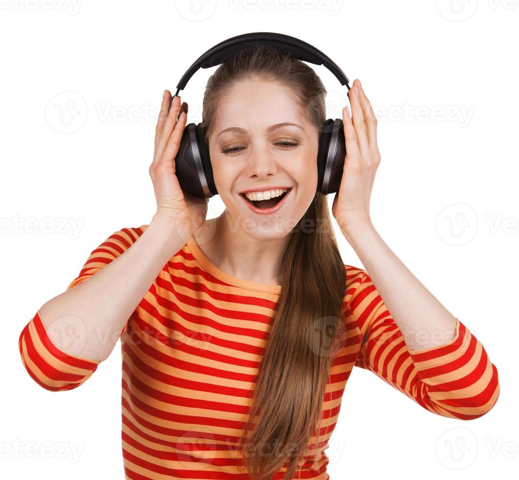 Happy girl listens to music on headphones photo