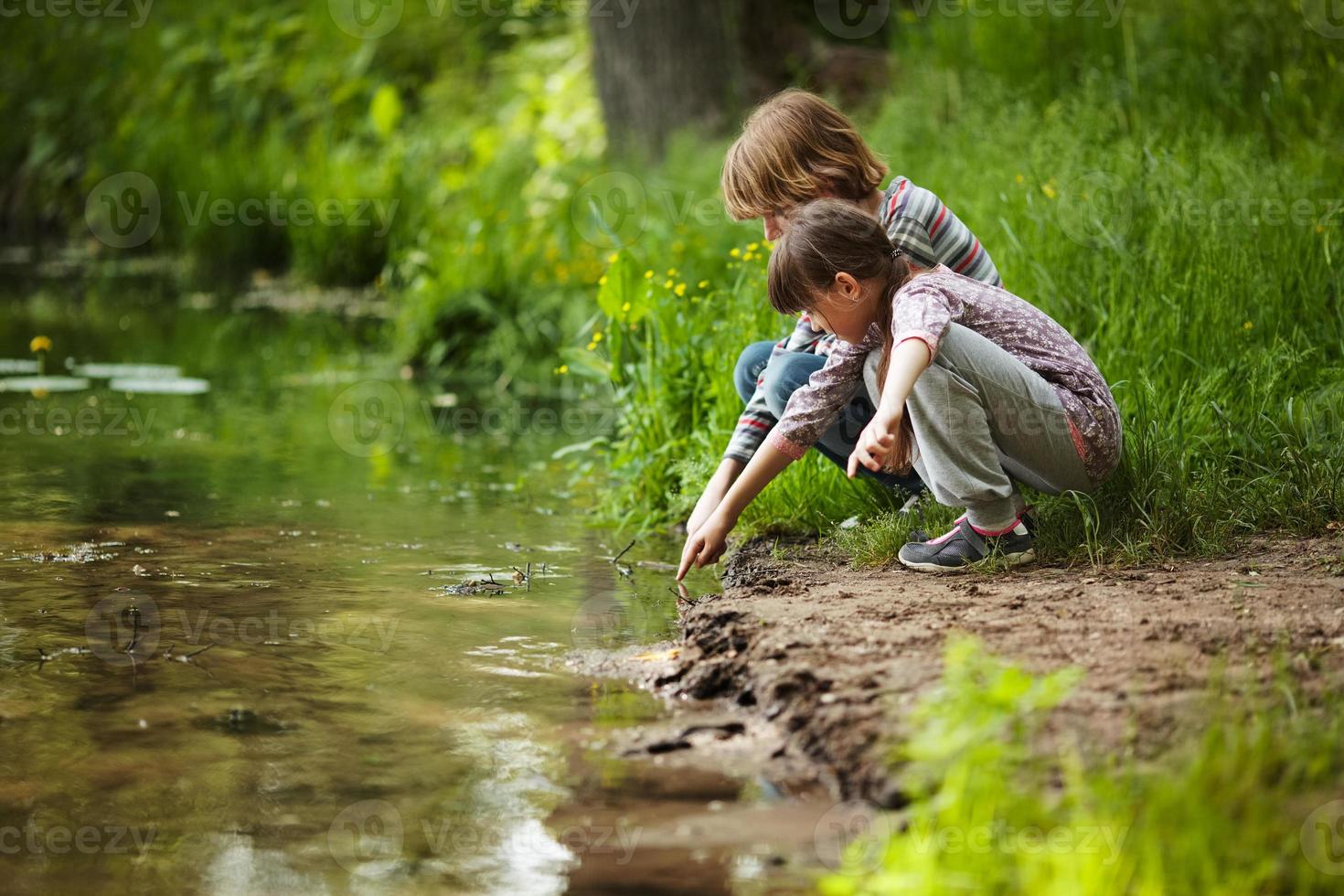 Boy with a girl near the water photo