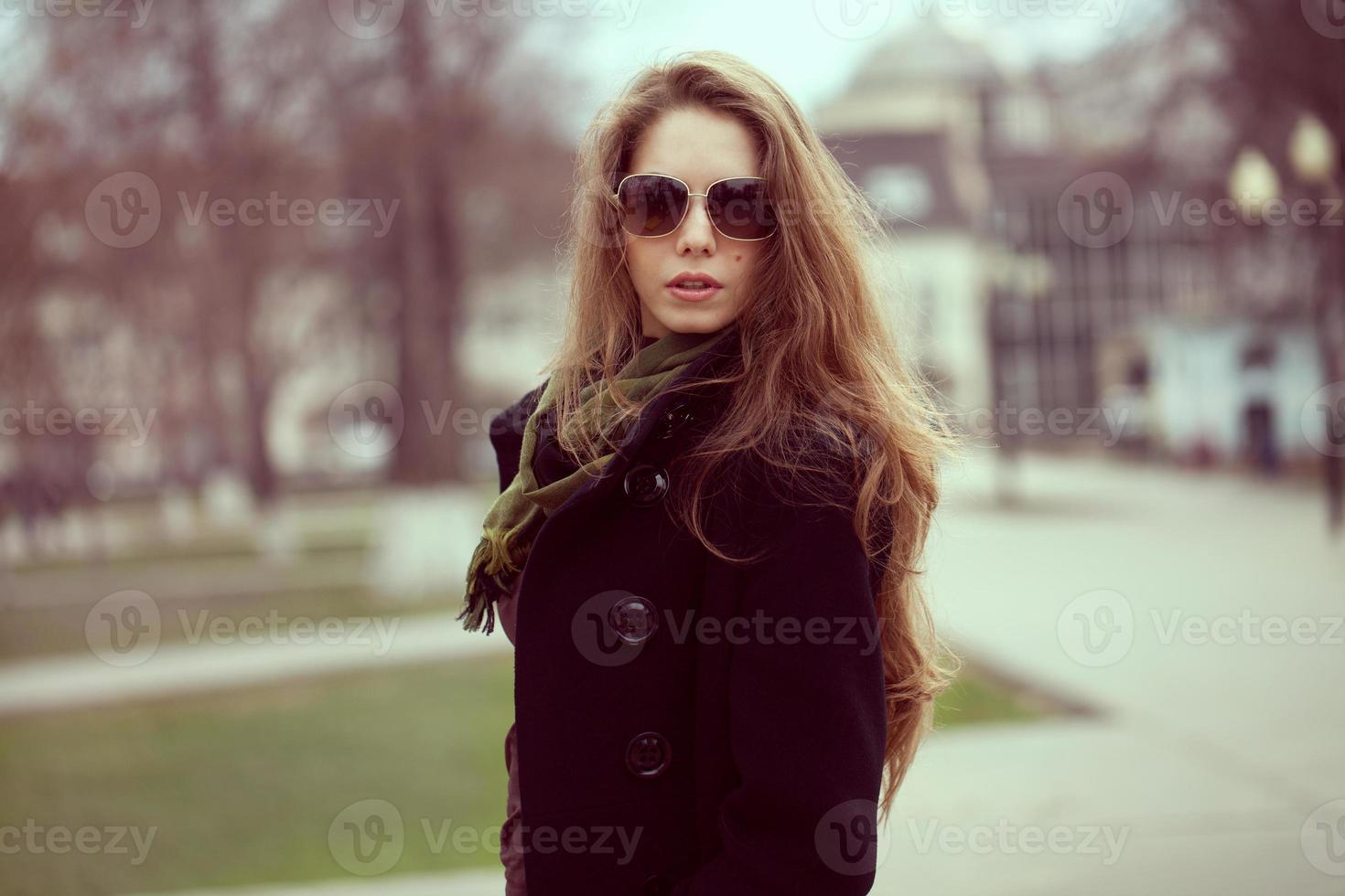 Stylish girl with long hair and glasses photo