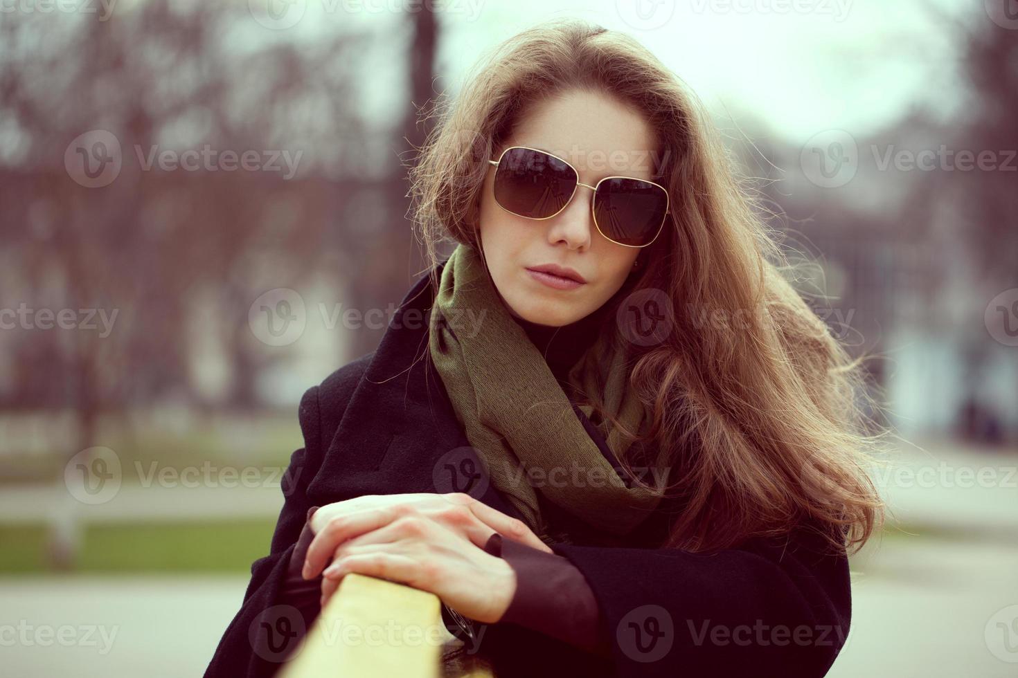 Beautiful young woman in sunglasses resting photo