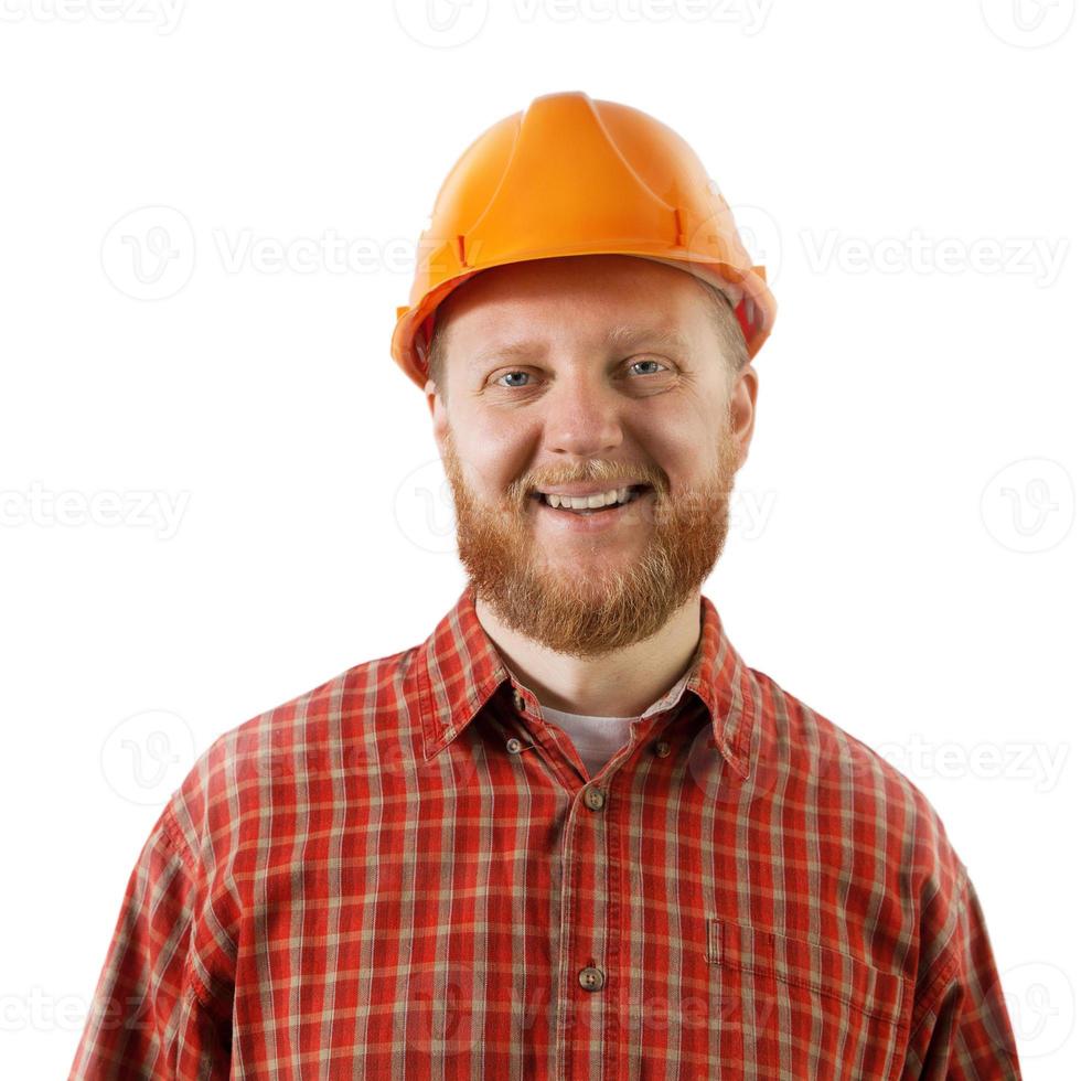 Hombre barbudo en un casco protector de construcción foto