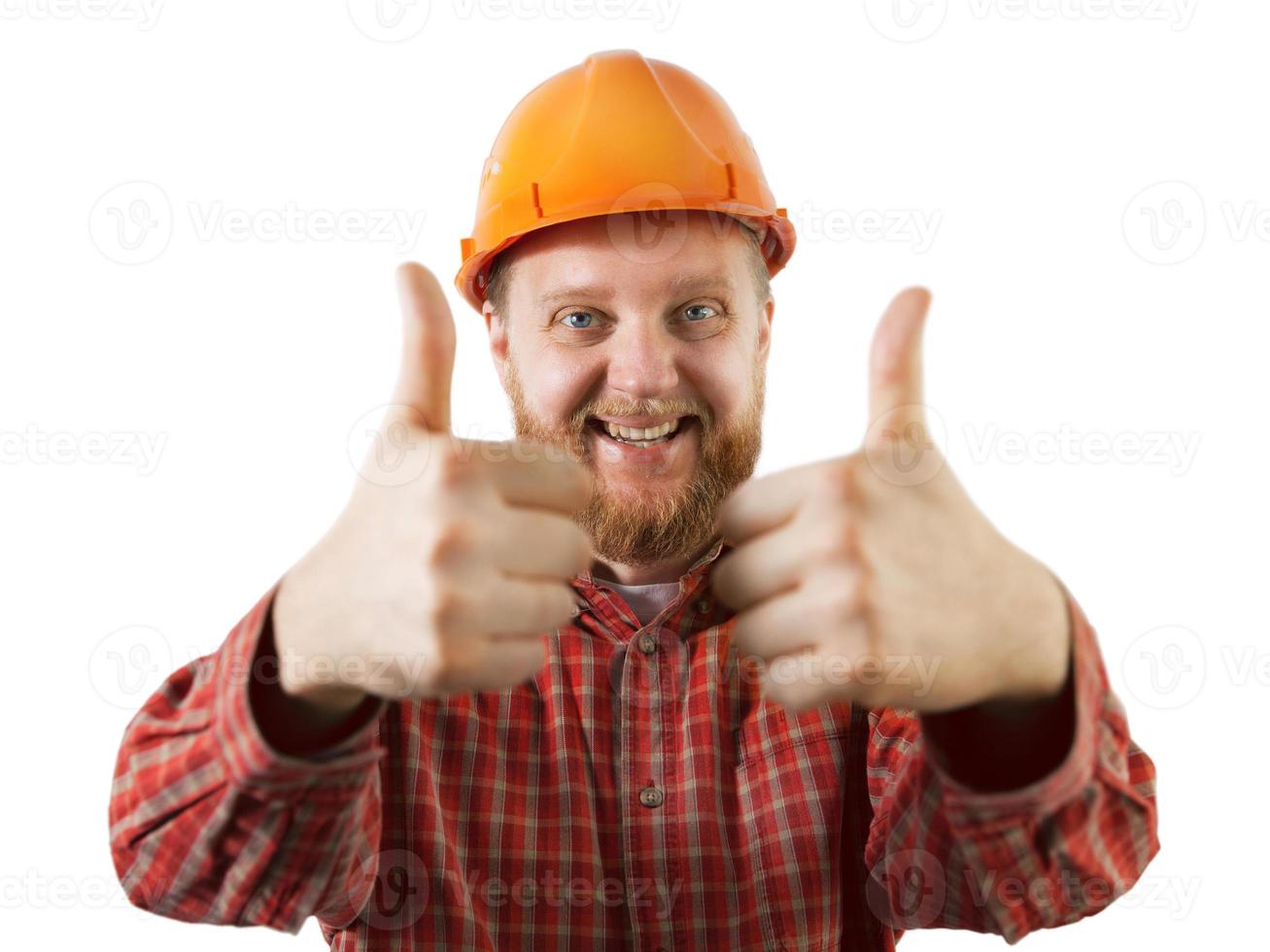 Hombre alegre en un casco de construcción naranja foto