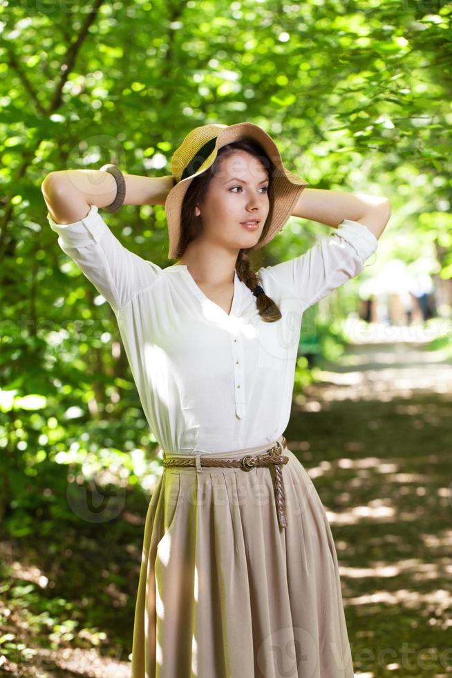 Beautiful young woman in an elegant hat photo
