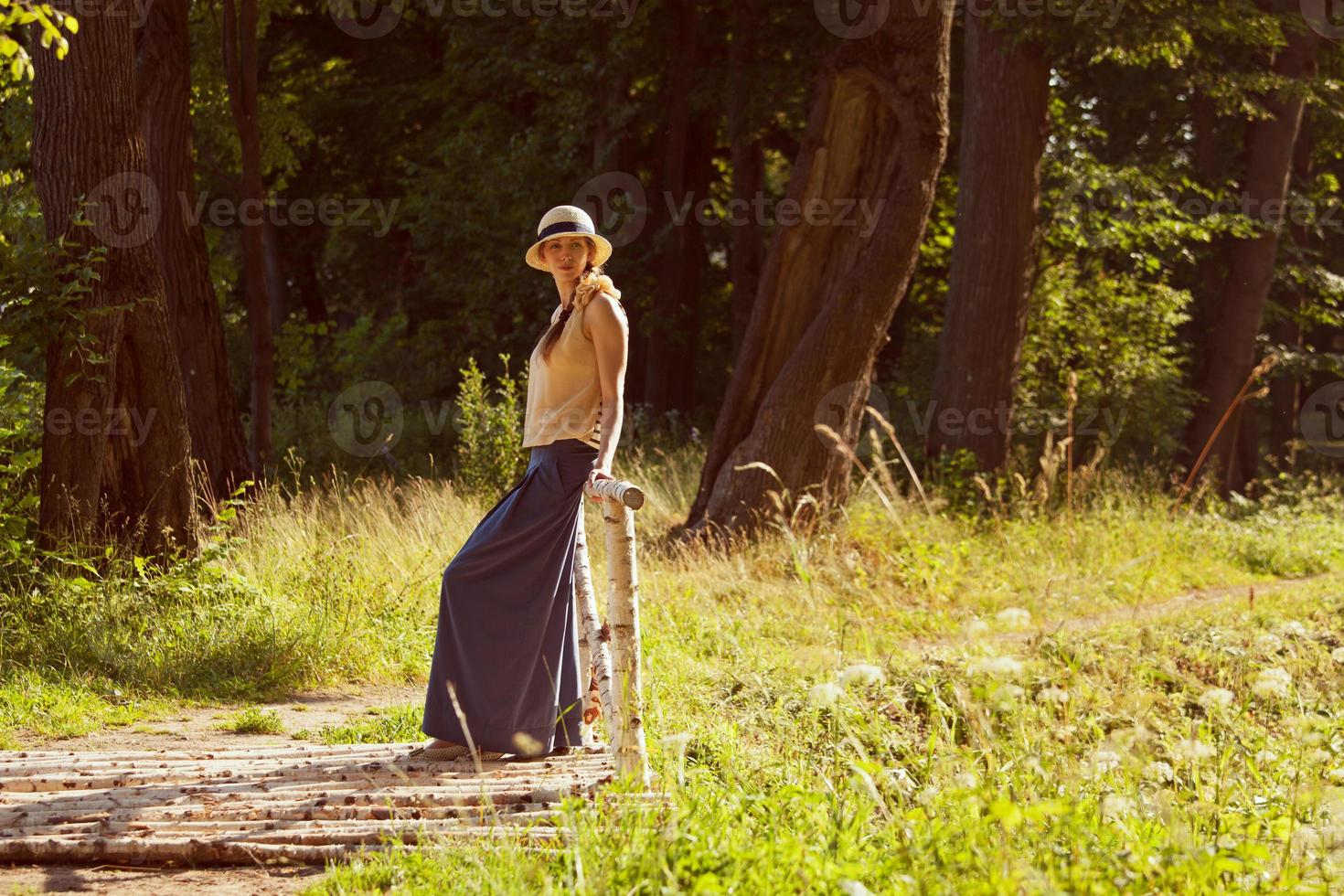 Woman standing in a park near the bridge photo