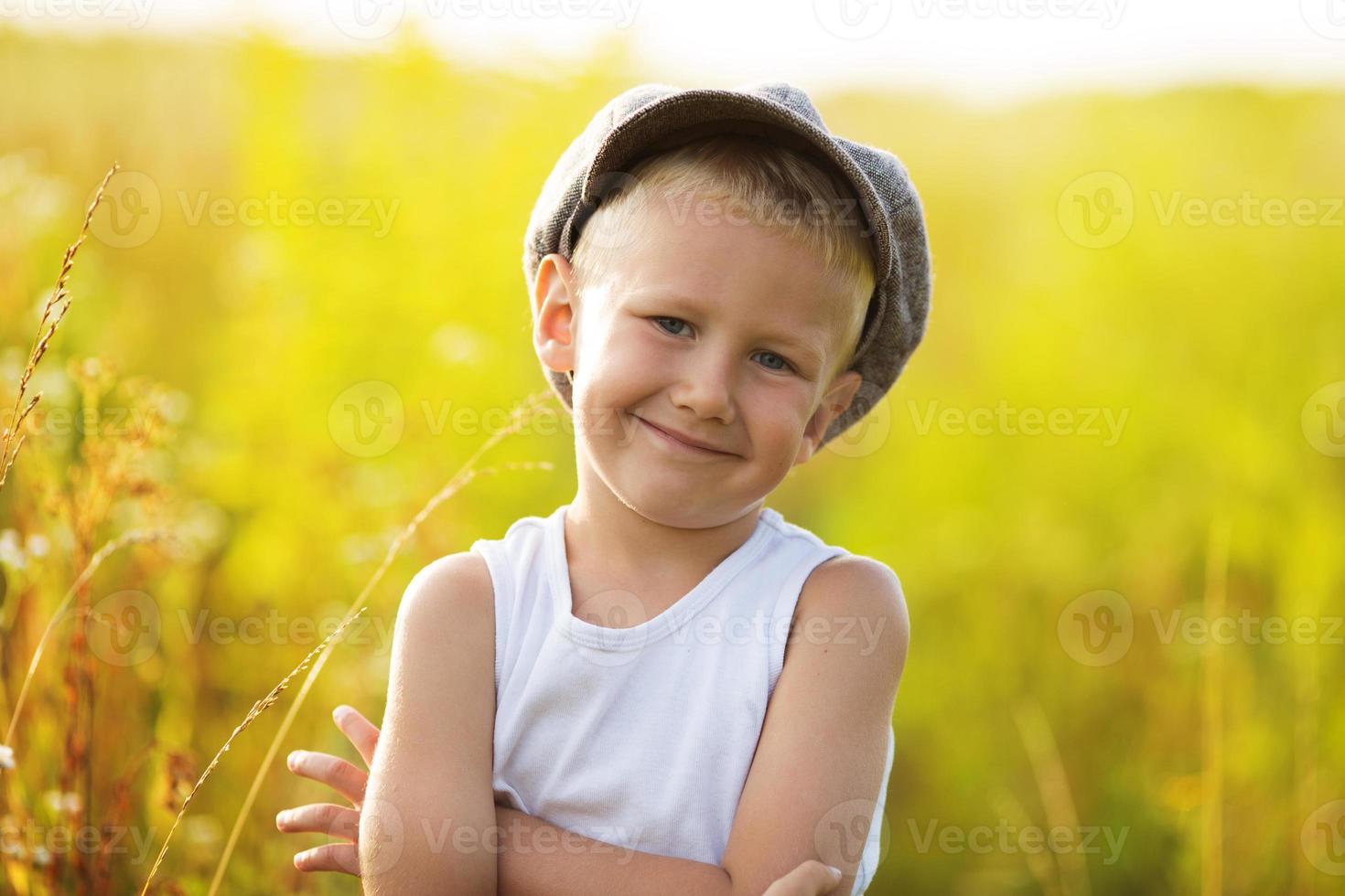 Happy little boy in a gray cap photo