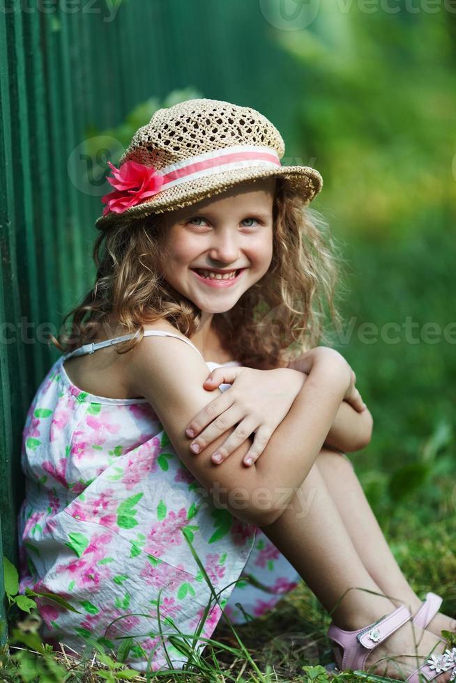 Happy little girl in a straw hat photo