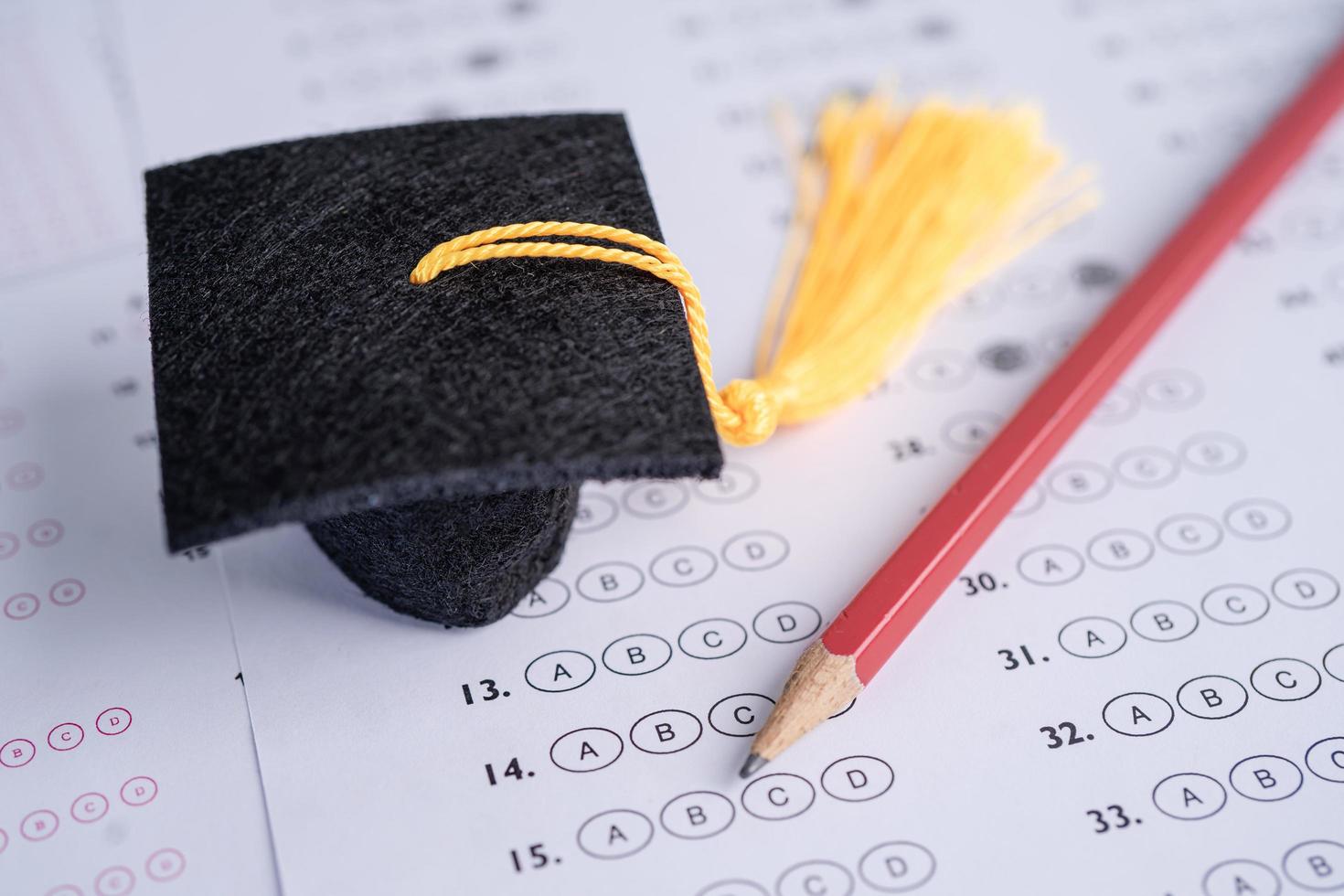 Graduation gap hat and pencil on answer sheet photo