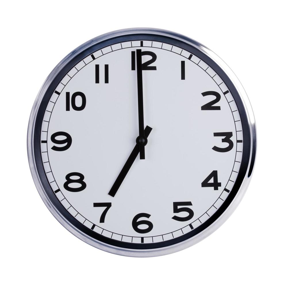 Round office clock shows seven o'clock photo