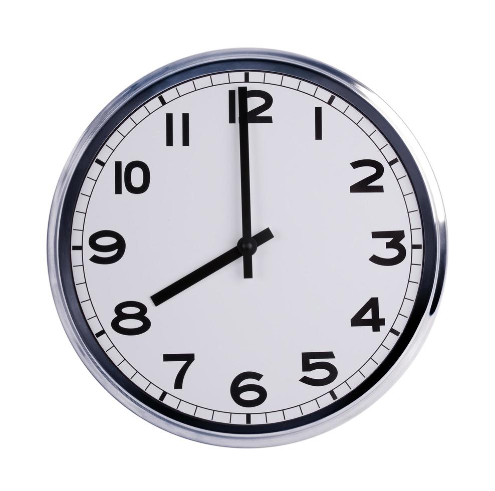 Round office clock shows eight o'clock photo