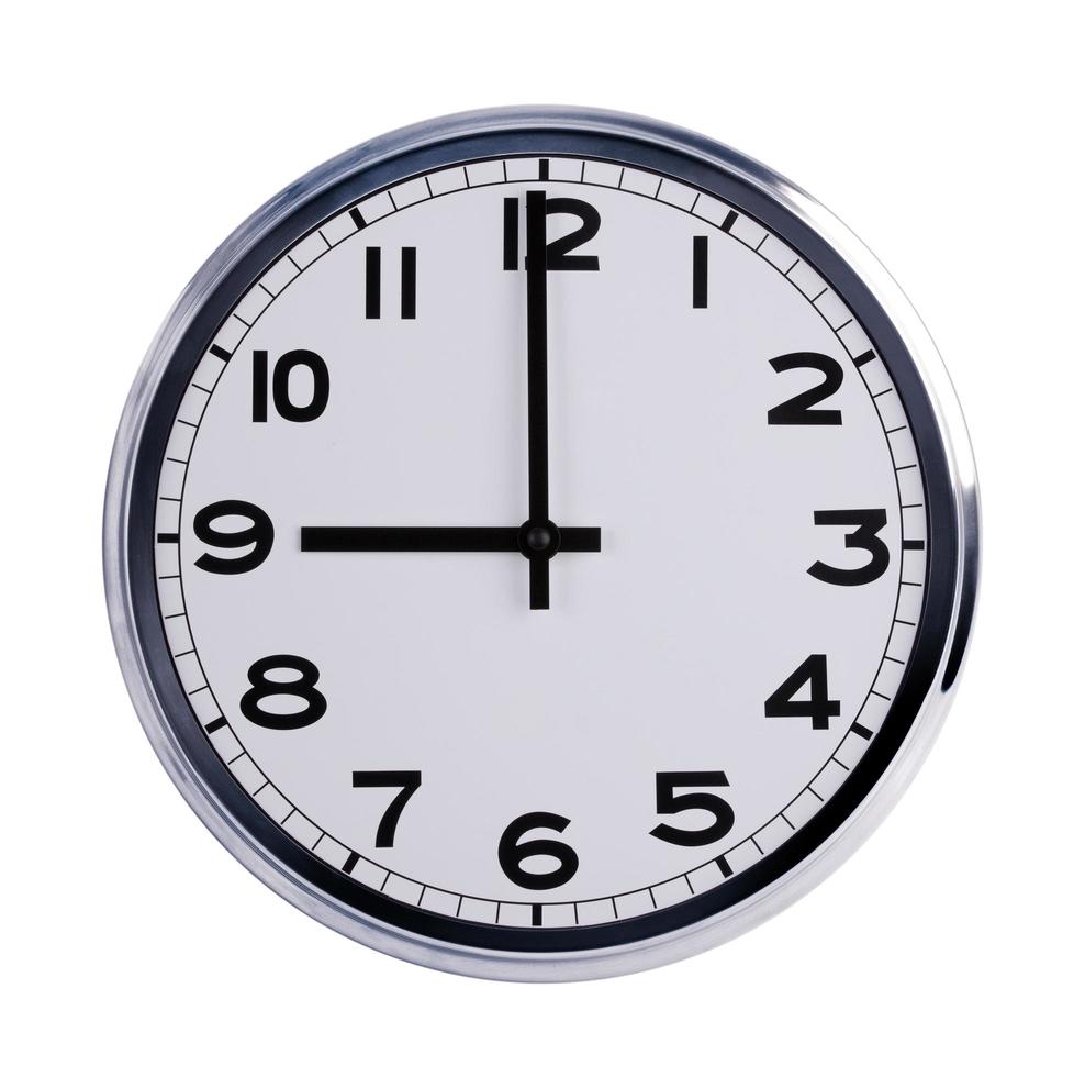 Round office clock shows nine o'clock photo