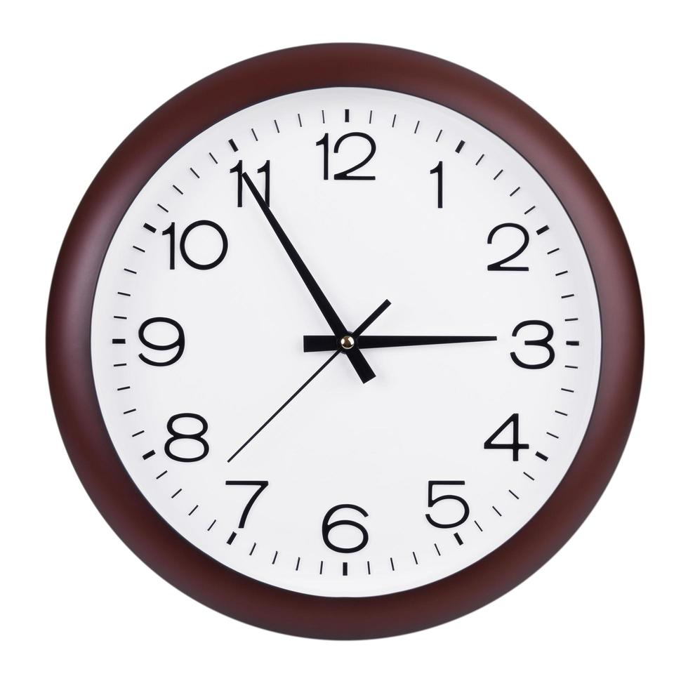 Round clock shows five minutes to three photo